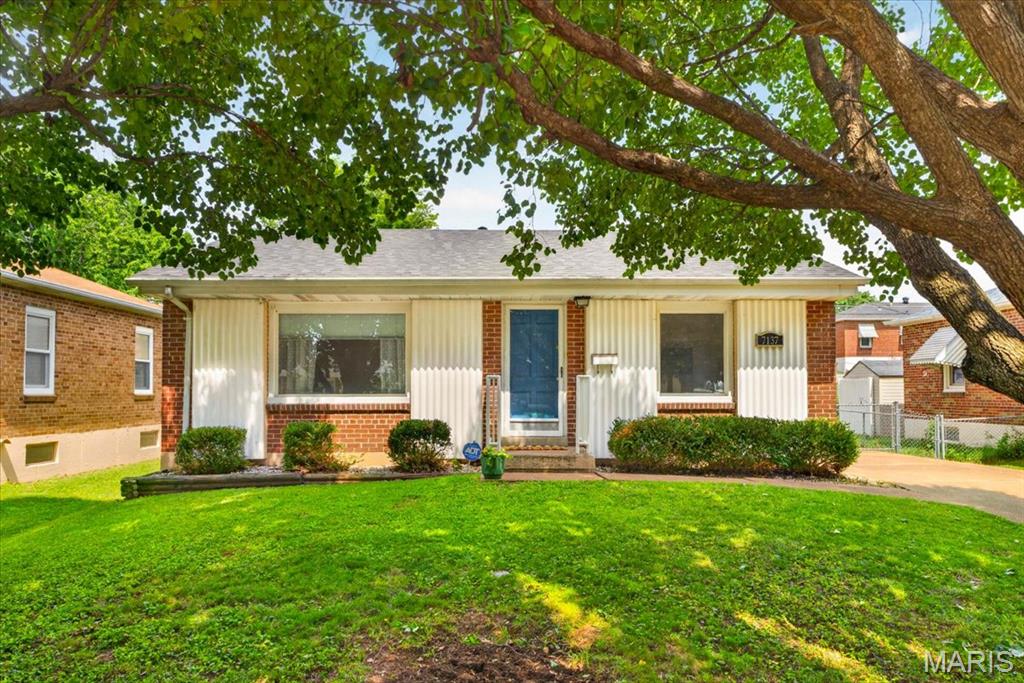 Some homes just have a story to tell.

7137 Marwinette sits one block from the sweeping green lawns and winding paths of Carondelet Park — the kind of address where morning walks become a ritual and the neighborhood feels like an extension of your own backyard.

Step inside and the hardwood floors greet you first, warm and gleaming under the light that pours through oversized windows. This is a home that was made to be filled with natural light, with laughter, with the smell of something good cooking.

And speaking of cooking — the kitchen has a story of its own. A French door KitchenAid refrigerator, gas range. Cabinetry reaching toward the ceiling, tiled backsplash, a garbage disposal, and counter space that practically begs you to host. Whether it's a quiet Tuesday dinner or a full Saturday spread, this kitchen is ready.

Two bedrooms, each with matching GE ceiling fans that keep things cool and comfortable through every season. A linen closet keeps the everyday essentials close. The full bathroom is thoughtfully finished with a tiled tub, a pedestal sink, a built-in medicine cabinet.

Head downstairs and the tale continues. The partially finished basement opens up with vinyl plank flooring underfoot, a second full bathroom with a stand-up shower, and a dedicated laundry room with a wash sink. The washer and dryer stay — because this home takes care of you.

Outside, a large backyard offers room to breathe, grow, and gather. A detached, finished garage anchors the back of the lot with heating and cooling.

Carondelet Park is a block away. South City's best restaurants, coffee shops, and community are minutes in every direction.

7137 Marwinette isn't just move-in ready. It's ready for your next chapter.