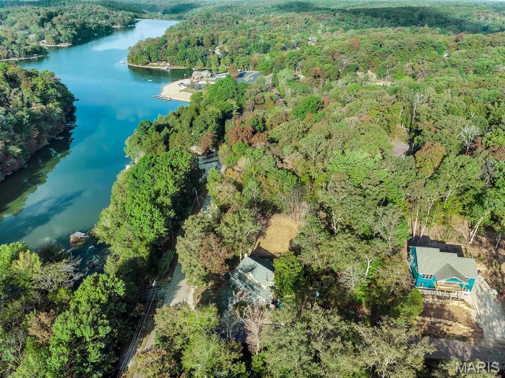 Looking for nature, lake life, and a peaceful retreat? Discover the desirable Lake Sherwood Estates and the opportunity to own a beautiful, cleared lot at 417 Marina Dr in a 24-hour gated lake community in Warren County. Multiple opportunities available with this property! Build your dream home, buy and use for access to the community, or buy the house next door (416 Marina Drive MLS #26048552) and use this property to have a larger yard or a place to build an adjoining garage! This level, cleared lot features an address marker and offers an easy building site, with seasonal views of the main lake. Water, sewer, and electricity are available for hookup if you choose to build, making this an excellent opportunity to bring your dream home to life. Enjoy a prime location within the community, just a short distance to the clubhouse, community pool, sandy beach on the main lake, and Lakeside Grill. Lake Sherwood offers an exceptional array of amenities and year-round recreational opportunities, including six lakes ranging from approximately 3 to 130 acres. The main lake is motorized, while the other five lakes provide ideal settings for non-motorized activities such as kayaking and fishing. Additional community amenities include a newer pool, campground facilities for overnight stays, sandy beach, a marina, and activities throughout the year. Whether you're looking to build a full-time residence, weekend getaway, or vacation retreat, this property offers the perfect setting to enjoy the outdoors and lake lifestyle. Located in the Washington School District and just minutes from charming downtown Marthasville, you'll also have convenient access to Augusta, Foristell, New Melle, and Washington. Plus, enjoy an easy approximately 35-minute drive to Chesterfield and quick access to some of Missouri's finest wineries. Come enjoy the best of lake living, nature, and community at Lake Sherwood — and start planning your dream home today! Keep in mind this is a gated community and you must have a Realtor with you to view this property. We invite you to come live the lake life at Lake Sherwood MO!
