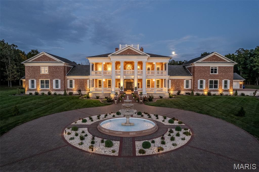 Presenting a magnificent gated full brick colonial estate set across 7 +/- acres of private, manicured grounds—an extraordinary expression of timeless architecture, grand scale, and uncompromising luxury. Spanning over 21,000 square feet, this residence stands as a true legacy property, with reconstruction valuations exceeding $10,000,000, underscoring the caliber of craftsmanship and materials throughout. From the moment of arrival, the estate conveys a sense of permanence and prestige. Inside, the home unfolds with remarkable intention, offering 7 lavish bedroom suites, 7 full baths, and 3 half baths, each space curated to balance opulence with livability. The main level is adorned with rich hardwood flooring and elevated by exquisite detailing, including Ralph Lauren wall coverings, Schonbek crystal chandeliers and finely carved Enkeboll moldings, evoking the elegance of a classic American manor. A series of grand yet inviting living spaces create an effortless flow for both intimate gatherings and large-scale entertaining. The formal dining room, complemented by a butler’s pantry, transitions seamlessly into the heart of the home—a chef’s kitchen outfitted with Viking appliances, 14' center island, custom buff cabinetry, granite surfaces, and extensive prep and service areas. Multiple auxiliary kitchens and bar spaces, each with integrated wine coolers and supported by a dedicated wine cellar, elevate the home’s entertaining capabilities to an exceptional level. The owner’s suite is a private retreat of rare distinction, featuring a fireside sitting room, a spa-quality bath with a soaking tub, towel warming drawer, and expansive dual dressing closets. A discreet private staircase leads to an exclusive executive enclave, complete with two offices, a den, and a private bar—offering a refined and secluded environment for work and relaxation alike. Architectural sophistication meets modern convenience with features such as a multi-level elevator, multiple staircases ensuring seamless circulation, a generously sized bonus and exercise suite with private garage access, and a fortified safe room for peace of mind. Beyond the interiors, the estate transforms into a resort-caliber sanctuary. A striking gunite pool with elegant fountains anchors the outdoor experience, accompanied by an exceptional pool house fully equipped with a complete kitchen, family room, dining area, two bedrooms, and two full baths, creating an ideal setting for guest accommodations or extended entertaining. Expansive covered verandas at both the front and rear invite year-round enjoyment, blending indoor refinement with the natural beauty of the surrounding landscape. This is not simply a residence—it is a statement of legacy and distinction, where classical design, masterful craftsmanship, and modern luxury converge on a truly extraordinary scale.