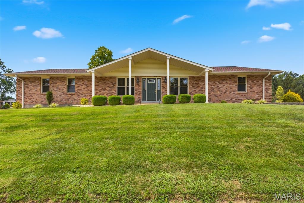 Exceptional custom-built ranch offering more than 4,000 square feet of beautifully finished living space in sought-after South County. Meticulously maintained and thoughtfully designed, this stunning residence is situated on a premier corner lot of nearly half an acre and combines timeless elegance with everyday comfort. The main level welcomes you with formal living and dining rooms, rich hardwood flooring throughout, and a breathtaking vaulted great room featuring exposed beams and a wood-burning fireplace with blower. The gourmet kitchen is both stylish and functional, showcasing granite countertops, a breakfast bar, stainless steel appliances, a generous pantry, and a sunny breakfast room ideal for casual dining. The spacious primary suite serves as a private retreat, complete with a large walk-in closet and primary bath. Two additional bedrooms and a full bath complete the main-floor sleeping quarters. The expansive finished lower level provides incredible versatility and space for entertaining, recreation, and extended living. Highlights include a family room, game area, playroom, two private sleeping rooms, a beautifully finished full bath, laundry room, salon space easily adaptable to a home office, fitness room, or hobby area, plus a large cedar closet and abundant storage. Pella windows flood the home with natural light, creating a bright and inviting atmosphere throughout. Step outside to enjoy the beautifully landscaped backyard featuring a gazebo, large-covered patio, basketball court, spacious, flat side yard, and a storage shed with electricity. An oversized two-car garage completes this remarkable property. A rare opportunity to own a spacious, move-in-ready home offering exceptional living and entertaining space in a desirable South County location.
