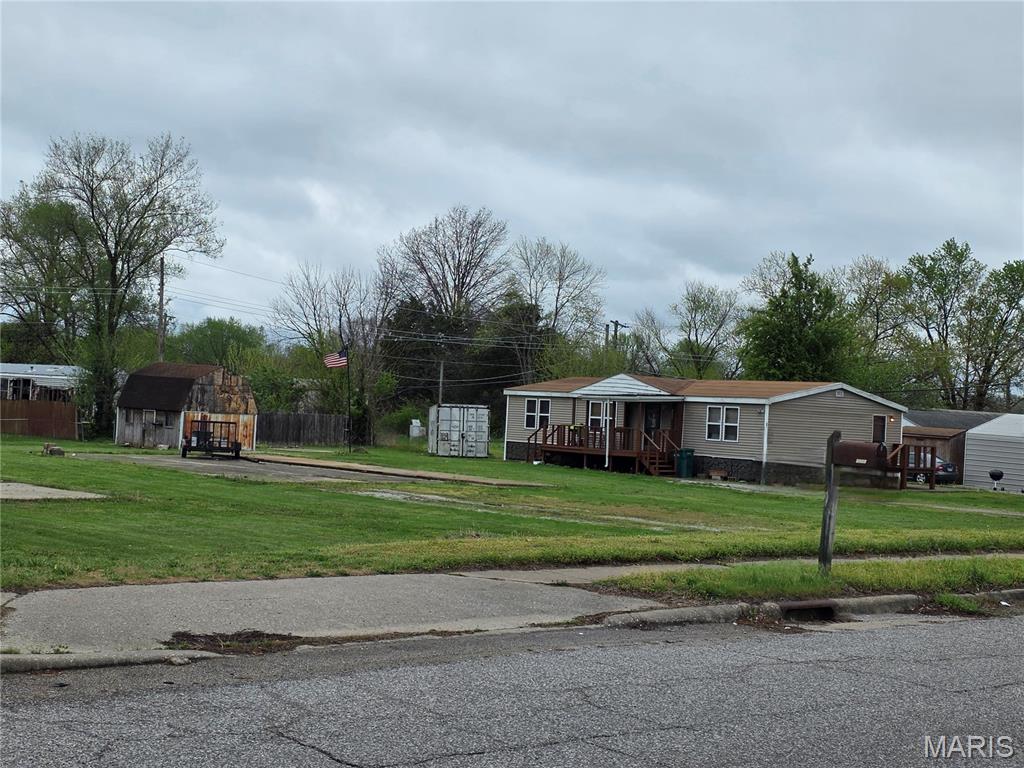 Possibilities are endless here. Address listed is the lot with the move in ready mobile home. Roof is known to be approximately ten years old.  Updated bathroom 2023, new hv/ac 2023. Set up perfect for that individual looking to live in a home without having to pay lot rent.  Better yet, exploring other investment options such as your own mobile home park that you get to control. Whether you're looking for an enormous yard or perhaps adding a few homes to the 3 additional lots.... This property is inclusive of four parcels with three additional mobile home pads, concrete poured utility ready. May even be able to build (check with Cahokia city confirmation) complete with newer covered deck on the front and one on the side entry. Large storage shed. There's even a built-in handmade bar.
Includes 4 parcels 06-12.0-210-014 at 2335 Jerome Lane, 06-12.0-210-013 at 2333 Jerome Lane, 06-12.0-210-012 at 2331 Jerome Lane and 06-12.0-210-011 at 2329 Jerome Lane
