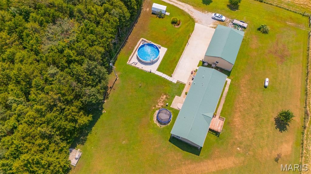 Your country lifestyle awaits just minutes from Rolla! Set on an impressive 23.08 acres m/l of fenced pasture, this beautiful property offers the rare combination of space, privacy, livestock potential, and convenient access to town. Follow the long driveway to a welcoming +/- 1,976 sq ft, 4-bedroom, 2.5-bathroom home surrounded by peaceful countryside. Step inside to an inviting open-concept design where the living room, dining area, and kitchen flow seamlessly together—ideal for everyday living and entertaining. Warm wood flooring adds character to the living and dining areas, while the kitchen is designed to be both beautiful and functional with custom cabinetry and a center island. The thoughtfully designed divided bedroom plan provides a private retreat for the primary suite, complete with a spacious ensuite bathroom featuring a relaxing soaking tub and separate shower. Three additional generous bedrooms with comfortable carpeting and a full guest bath provide plenty of room for family and guests. A convenient laundry area and half bath are located just off the kitchen. The outdoor amenities make this property truly special. The expansive fenced pasture is ready for livestock and offers endless possibilities for recreational use, gardening, or simply enjoying the wide-open surroundings. An oversized 2-car detached garage provides exceptional space for vehicles, equipment, hobbies, and storage, while the above-ground pool creates the perfect spot to relax and enjoy summer days. The home and garage feature durable metal siding and metal roofs for added longevity and low-maintenance appeal. With 23.08 acres, a spacious open-concept home, private primary suite, oversized garage, pool, fenced pasture, and a location just minutes from Rolla amenities, this is an exceptional opportunity to enjoy the freedom of country living without sacrificing convenience. Come experience the space, possibilities, and lifestyle this property has to offer!