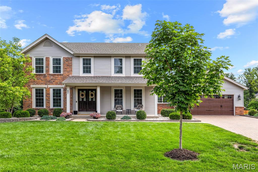 Bask in the opportunity to live in the highly sought-after Timberwood Trails featuring updates throughout. Offering 4 bedrooms, 2.5 baths & approximately 3,300 square feet of living space, this home is loaded with charm & modern upgrades. A paver driveway & inviting front porch create beautiful curb appeal. Step inside to a dramatic 2-story foyer with newer laminate flooring & updated modern fixtures. The main level includes a formal office or family room, separate dining area & a spacious living room with a bay window & cozy brick fireplace. The gorgeous updated kitchen features Silestone countertops, new Shaker-style cabinets with crown molding, a center island with seating, coffee nook & adjoining breakfast room. A charming window bench with additional storage adds warmth & functionality. Main-floor laundry & a convenient half bath complete the first level. Take the new wrought-iron staircase up to the spacious owner’s suite with a walk-in closet, dual vanity, separate tub & shower. Three additional bedrooms plus an updated full bath complete the upstairs. The light-filled walk-out lower level includes a kitchenette, exercise room or sleeping area & large family/recreation room with an electric fireplace. Enjoy your days & nights out back on the patio including a brand new privacy fence. Plenty of room for seating & entertaining on over a 1/3 of an acre lot. Additional highlights include a newer roof and siding, sprinkler system, and newer garage door. Located just three doors from the subdivision pool and courts in this fantastic golf cart community, this prime Cottleville location is close to parks, shopping, schools, dining, and entertainment!