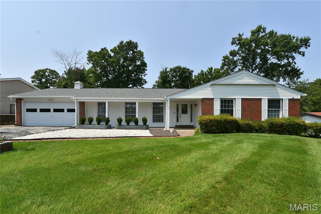 Welcome home to this beautifully renovated 4-bedroom, 3-bathroom property offering the perfect blend of classic charm and modern living. High-end finishes and thoughtful design details are showcased throughout this exceptional home. Gorgeous hardwood floors flow throughout the main level, featuring a formal living room and dining room along with a beautifully renovated open-concept floor plan. The inviting family room is highlighted by an electric fireplace and custom TV wall, creating a sophisticated yet comfortable space for relaxing or entertaining.

The finished lower level provides additional living space with a dedicated office and  bar/ tv area, offering flexibility for work, entertaining, or recreation. Step outside to enjoy the screened-in porch, spacious patio, fenced yard, and established organic vegetable garden—perfect for pets, gardening, and outdoor gatherings. A convenient 2-car garage provides ample parking and storage.

Combining high-end finishes, modern updates, versatile living spaces, and exceptional indoor-outdoor living, this beautifully appointed home is truly move-in ready and designed for both everyday comfort and effortless entertaining.