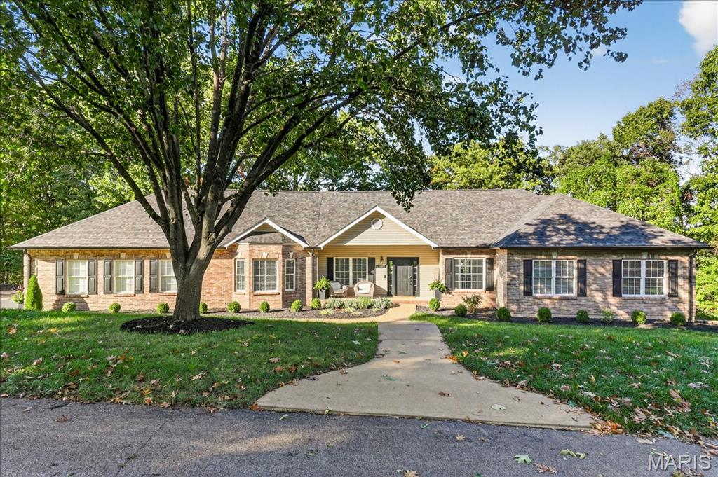If you’ve been dreaming of space, privacy, and a home that feels like your own retreat this is it. Perfectly positioned on five scenic acres near the end of a quiet cul-de-sac, this remarkable property offers the best of both worlds: peaceful, wooded surroundings and the convenience of being just minutes from town. Step inside and discover a home where timeless design meets modern comfort. The heart of the home is a stunning great room with gleaming hardwood floors, coffered ceiling, crown molding, and a wood accent wall that adds warmth and character. The gourmet kitchen blends function and style with custom cabinetry, granite counters, stainless appliances, a large eat in island, and under cabinet lighting. The adjoining family room features vaulted ceilings, a cozy wood burning fireplace, and access to a brand-new deck ideal for effortless indoor outdoor living. The primary suite is a peaceful retreat with hardwood floors, a walk-in closet, and a spa inspired bath featuring dual vanities, soaking tub, and walk-in shower. Two well appointed bedrooms are spacious and thoughtfully updated. The finished lower level expands the living space with a large recreation room, full wet bar, bonus room, and two additional bedrooms with new carpet and lighting perfect for guests or entertaining. Two expansive decks overlook the tree lined property, offering tranquil spaces to relax, entertain, or simply enjoy the changing seasons. With beautiful updates throughout, a new roof and fresh modern finishes, this is the private retreat you’ve been waiting for, don’t miss out!