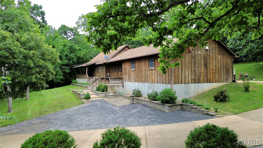 JUST LISTED IS THIS RARE FIND! This home is tucked away on a beautiful 3.2 +/- park-like acres. Spacious 4 bed 2 bath 1.5 story with approximately 1945 sq. ft. of living space based on a recent appraisal. Not located within a subdivision so no HOA rules apply. Convenient location. Oversized 2 car garage. Spacious kitchen with lots of counter and cabinet space. Spacious master bedroom is on the main floor along with the second bedroom. Upstairs you will find the additional bedrooms and second bathroom. Wood burning fireplace. Main floor laundry. The full basement is unfinished. Buy this home and make it your own oasis. The possibilities are endless with this property due to the lot size.  Home is being sold as-is due to the sellers circumstance. Great home and investment for a buyer willing to put some sweat equity into it.