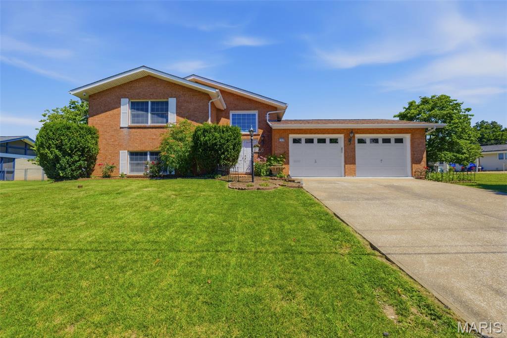 Solid brick split-level home on a quiet cul-de-sac in the highly rated Festus School District. Situated on a large, mature lot with fruit trees, this 3-bedroom, 2.5-bathroom property offers excellent functional space across two levels. The main floor features a spacious living and dining combination alongside a bright, eat-in kitchen overlooking the private backyard. The primary bedroom includes wood floors, a walk-in closet, and a full en-suite bath. A convenient half bath completes the main tier. The lower level adds significant living space with a large family room, a brick fireplace hearth, a wet bar, a dedicated home office, and two additional bedrooms serviced by a full bath with double sinks. A spacious patio room provides excellent bonus space for storage or hobbies. Features a massive 700 sq ft attached 2-car garage with built-in storage. Major upgrade: HVAC fully replaced in June 2025. Water heater 2021. Excellent location close to schools, highway, and parks. 
Showings begin Thursday. Open House Saturday, June 27, from 11:00 AM to 1:00 PM.