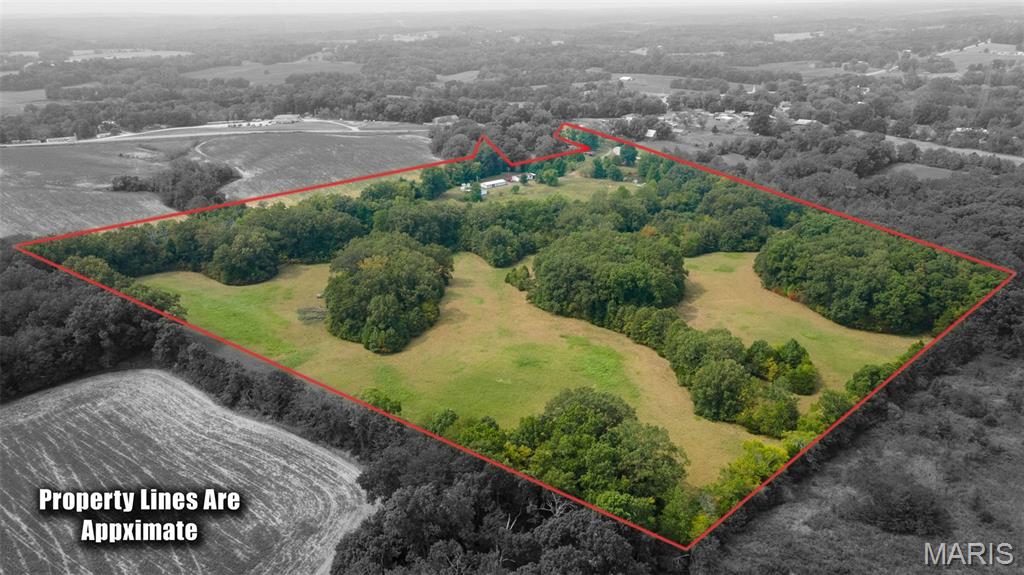 This stunning 38.32-acre property offers endless possibilities, whether you're envisioning your dream home, a hunting ground, a subdivision, or a rental development. The main level features a 2-bedroom, 2-bath house.  The house boasts a newer roof for added peace of mind.   Also included are two 3-bedroom, 2-bath manufactured homes; one requires some remodeling, while the other is currently rented. In addition, there are two shops on the property, 24X72 with heat, window unit, bathroom and kitchen, which was previously used as a ceramic shop. Another shop is 37X41, it has a concrete floor and is perfect for storing and working on vehicles.
 The property is equipped with one septic system for the stick-built house and a shared septic for the manufactured homes and shop.  You'll also benefit from public water, natural gas, two ponds, a creek, and abundant wildlife, making it a hunter's paradise. Please note, the property is sold "As Is" and the sale is contingent upon the seller finding suitable housing.