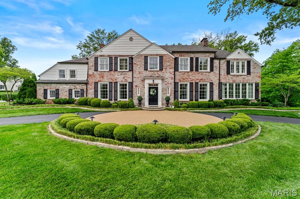 Nestled within the tree lined streets of Ladue’s prestigious Briarcliff subdivision, this extraordinary two and a half story brick residence is a masterful blend of timeless elegance and inspired modern living. Set upon beautifully landscaped grounds, the home exudes a sense of quiet sophistication, where every space has been thoughtfully curated and every detail meticulously considered. A grand entry welcomes you into interiors rich in character, unfolding into gracious formal rooms designed for both intimate gatherings and large scale entertaining. Sunlight pours through expansive windows into the stunning family room, where custom built ins, new flooring and refined finishes create an inviting yet elevated atmosphere. At the heart of the home, the recently renovated kitchen reflects both exceptional craftsmanship and effortless functionality, seamlessly connecting the home’s living spaces. The primary suite serves as a private sanctuary, complete with a luxurious renovated bath, dual closets, and a sun drenched sitting room that feels worlds away from the pace of everyday life. Additional bedroom suites and an in law arrangement offer comfort and flexibility, while the fully remodeled lower level provides beautifully finished recreation and lounge spaces with custom bookcases, a full bath, and generous storage. Throughout the home, French doors frame picturesque views of the professionally landscaped grounds and open to an elegant paver patio, creating a seamless connection between indoor and outdoor living. Extensively enhanced with a recent design transformation by Denise Fogarty Interiors, the residence also features newer HVAC systems and water heater, extensive surveillance upgrades, Anderson replacement windows, all new shutters, and a freshly painted brick exterior. Rarely does a home so effortlessly balance enduring architectural charm with such a comprehensive level of modern refinement, all within one of Ladue’s most admired and established neighborhoods.