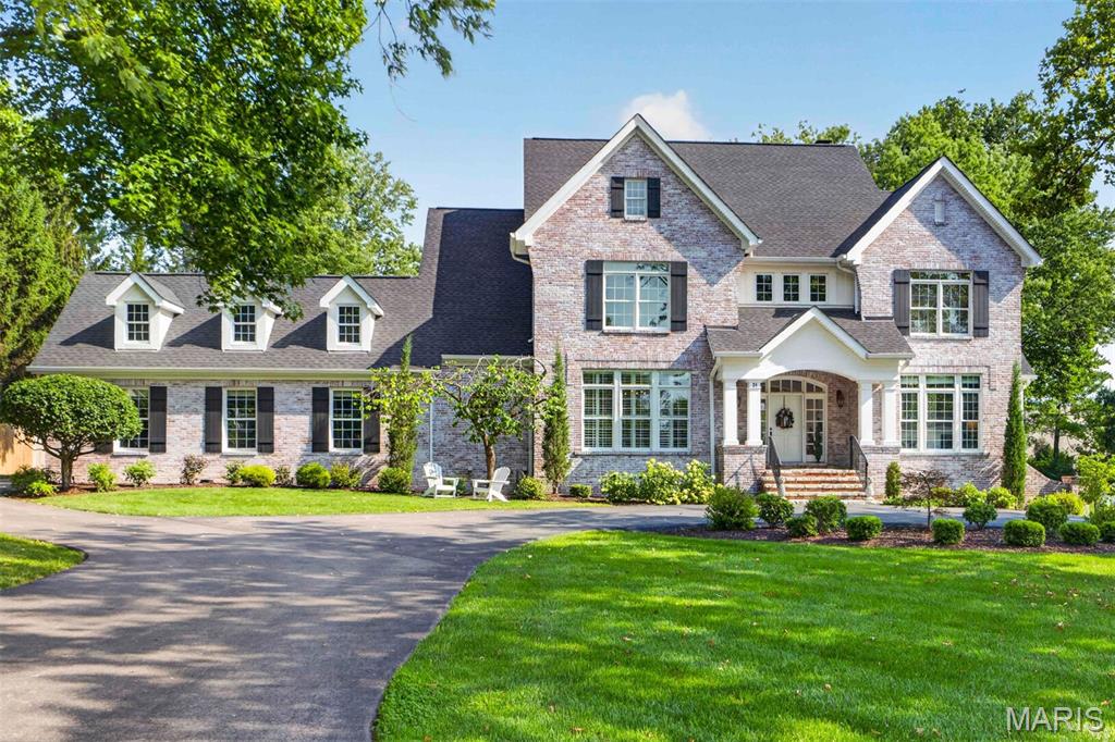 Exceptional craftsmanship and distinctive design elements define this spectacular 2-story brick Colonial in Ladue School District. An open floor plan features well-proportioned rooms with soaring ceilings, detailed trim work, designer lighting, and beautiful hardwood floors throughout the main living areas.

A wide brick porch and inviting foyer welcome you into an elegant dining room featuring a gorgeous tray ceiling, designer wallpaper, and custom molding. Cased arched entryways frame the stunning great room, complete with a beamed ceiling and views of the beautiful outdoor living space.

Culinary enthusiasts will love the designer kitchen, appointed with crisp white cabinetry, marble countertops, Sub-Zero appliances, and a center island. The adjoining breakfast room flows seamlessly into the hearth room, featuring a stone fireplace and sliding glass doors leading to the patio and pool.

The coffered primary bedroom suite provides a luxurious private retreat, highlighted by a customized walk-in closets and spa-like bath. Upstairs, three generously sized additional bedrooms, a loft area, and a convenient laundry room provide exceptional comfort and functionality.

The finished lower level offers an impressive entertainment and recreation space, including a recreation room, workout room, a possible sleeping area, full bath, private office, and wellness suite. 

Outdoor living is truly exceptional, with a gunite pool, fire pit, expansive patio, and pergola creating the perfect setting for entertaining and relaxing. Situated on a premium lot with a circular drive and three-car garage, this remarkable home offers an exceptional blend of timeless architecture, sophisticated design, and resort-style living.