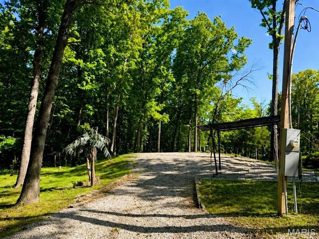 2 Lots!! Escape to tranquility with these mostly cleared lake lots perfectly suited for your camper and featuring convenient electric hookups and septic. Or you can enjoy the sounds of nature inside the screened room built on the property.  Located within a secure gated community, this property offers a peaceful retreat ideal for weekends or extended stays. Bring the whole family and enjoy  your days fishing, boating, swimming in the lake, or relaxing on the sandy beach. The community boasts pickleball and tennis courts, making it easy to stay active and entertained. Explore miles of scenic roads, perfect for riding your SXS and enjoying the breathtaking surroundings. Lake lots with electric hook-ups and Septic are rare, so don’t miss this opportunity. You can simply back your camper in and hook right up. Pinnacle Lake is located less than an hour from Mid Rivers Mall, making this a great alternative to the larger, more populated lake getaways.