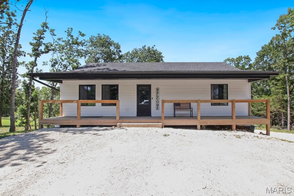 Newly built ranch home at Peaceful Valley Lake! This 3 bedroom, 3 bathroom home also offers a non-conforming 4th bedroom, providing plenty of space for family and guests. Enter through the large covered front porch into an inviting open floor plan featuring vaulted ceilings, a center island, and beautiful views overlooking the back deck. The main level includes a spacious primary suite with a private bathroom and walk-in closet, an additional bedroom with a walk-in closet, full bath, pantry, main floor laundry, and an extra wide hallway designed for comfort and convenience. The finished walkout basement offers even more living space with one bedroom, a non-conforming bedroom with walk-in closets, a full bathroom, and access to the oversized one car garage. Beyond your doorstep, enjoy all that the 175-acre Peaceful Valley Lake community has to offer, including a clubhouse, swimming pool, beach area, playground, tennis courts, and marina. Bring your family, friends, and your boat to enjoy boating, tubing, fishing, and relaxing on the water. Schedule your showing today!