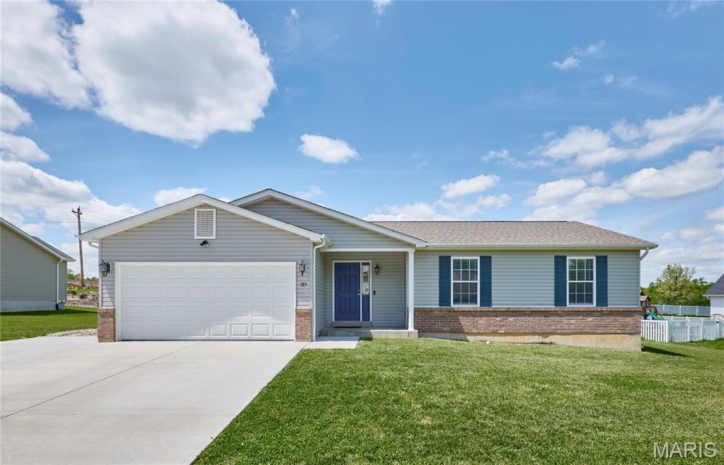 HUGE PRICE IMPROVEMENT!!!  Why build when you can buy this LIKE-NEW four year old BEAUTY and MOVE RIGHT IN!!!  Welcome to 121 Arundel Drive in Troy, Missouri — a thoughtfully designed home offering comfort, functionality, and modern style. This well-maintained 3-bedroom, 2-bath home offers inviting living space. The open-concept layout creates a natural flow between the living, dining, and kitchen areas, making it easy to enjoy both everyday living and time spent with family and friends. The kitchen features an abundance of stylish cabinetry and countertops with appliances that include an electric range, microwave, dishwasher & garbage disposal. Durable luxury vinyl plank flooring adds both style and practicality to this lovely home. The primary suite offers a quiet retreat, complete with a spacious closet and a private bathroom featuring a single vanity and tub/shower enclosure. Two additional bedrooms and another full bath provide flexibility for guests, a home office, or growing households. Situated on a large level lot, the property includes a nice yard, a covered front porch, two-car attached garage & additional parking pad. With close proximity Troy, local schools, shopping places, Highway 40/61 and everyday conveniences, this home combines comfort and accessibility in a desirable location. StoneBridge is a family-friendly community with a pool, playground and basketball court.  What are you waiting for?, Grab this wonderful opportunity to own and enjoy modern living in a welcoming community.