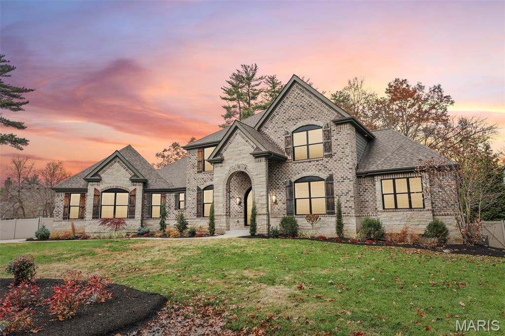 Impeccably maintained and masterfully crafted, this extraordinary 1.5-story luxury residence offers more than 5,300 sq ft of impeccably curated living space, where timeless elegance meets modern sophistication. From the moment you arrive, the home’s presence is unmistakable - set gracefully on a quiet cul-de-sac along a private lane in the heart of Creve Coeur, surrounded by mature landscape that enhances both beauty and privacy. Every inch of this residence reflects exceptional care, thoughtful design, and the finest quality workmanship.

A commanding brick and stone, complemented by LP SmartSide siding, Pella windows, and stately wrought-iron entry doors, introduces a home built to impress. Inside, the refinement continues with rich architectural detailing: extensive crown molding, casings, baseboards, solid hardwood flooring, and a custom handcrafted wood staircase that serves as an architectural centerpiece. Sunlight pours into the two-story great room, showcasing its dramatic floor-to-ceiling stone fireplace - an awe-inspiring space that flows effortlessly into the formal dining room and elegant first-floor office.

At the heart of the home is a stunning chef’s kitchen designed for both beauty and performance. Outfitted with premier Thermador Professional appliances, including a gas range, second built-in oven, drawer microwave, and an impressive 48" built-in refrigerator, this culinary sanctuary is further elevated by quartz countertops, under-cabinet lighting, a beverage-ready wet bar, and soft-close custom cabinetry. The adjoining hearth room, warm and inviting with its own fireplace, extends naturally to an exceptional covered outdoor living room—complete with stone fireplace, mounted TV, and sweeping views of the peaceful grounds. It is an ideal setting for year-round relaxation and gracious entertaining.

The main-floor primary suite is a sanctuary of comfort and indulgence, featuring a spacious layout and a spa-inspired bath adorned with custom tile and marble finishes. Upstairs, three large bedrooms and a generous bonus room create a perfect balance of luxury and livability for family or guests.

The beautifully finished lower level expands the home’s living experience even further, offering a spacious recreation room, full bar, additional bedroom, and full bath—perfect for long-term guests, entertaining, or creating the ultimate retreat space. Even with a 1200 finished area, there is still an abundance of unfinished space to expand or for storage.

High-efficiency zoned HVAC, a tankless water heater, a thoughtfully designed mud room, and exceptional craftsmanship at every turn ensure this residence lives as wonderfully as it looks.

This is luxury at its most refined—a meticulously maintained masterpiece in a premier Creve Coeur location. Homes of this caliber are rare. Don’t miss the opportunity to experience it.