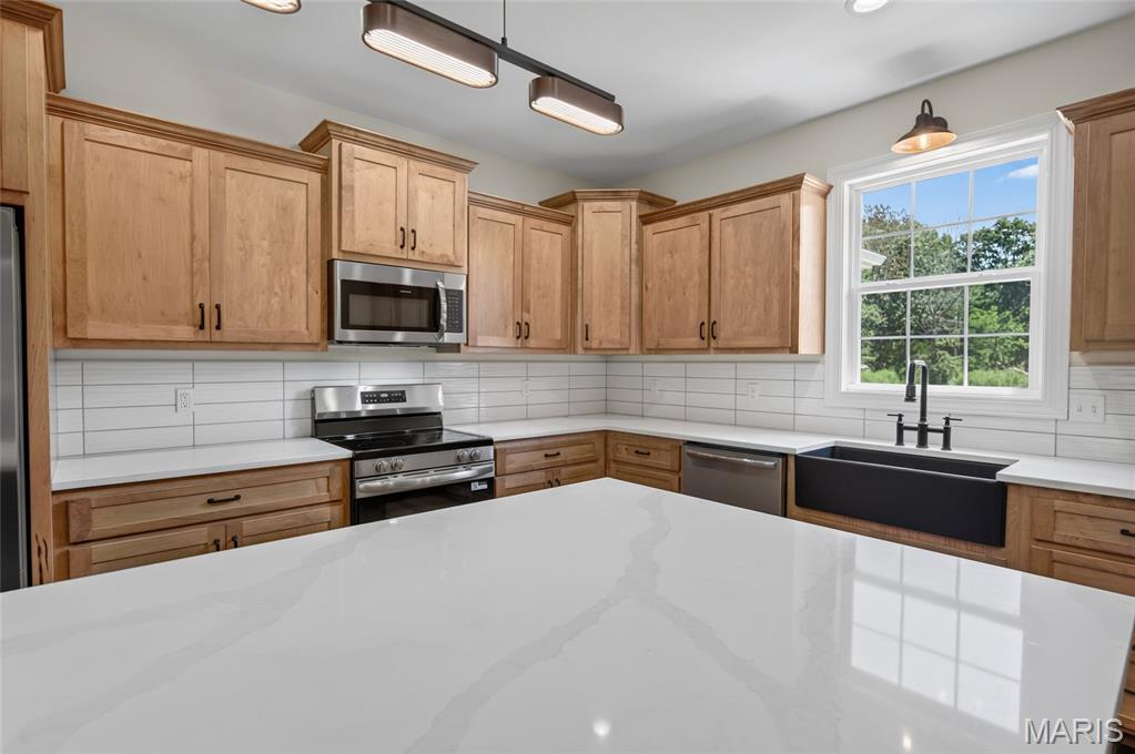 Construction is now COMPLETE on this beautiful home on Patton Lane! This builder doesn't miss a single detail & adds tons of custom features in all their homes. Located on a .48 ac lot in a quiet neighborhood just on the edge of town on a PAVED ROAD, this 2,430 sq. ft. home offers the most desirable floor plan around with 4 bedrooms (all with walk-in closets), 2.5 baths, & a 2-car attached garage. The spacious kitchen has gorgeous quartz countertops, a huge center island, custom cabinets, a spacious walk-in pantry, & SS appliances. Gorgeous hardwood floors & tile flooring along with 9’ ceilings throughout. The living room has a vaulted ceiling w/ custom wood beam. A large primary suite includes a stunning bathroom with double sink vanity, a walk-in custom tiled shower, a freestanding soaker tub, chandelier, & large walk-in closet. The floor plan features the much-desired split bedroom layout AND a 4th bedroom/office. Includes a 1-year builder's warranty!