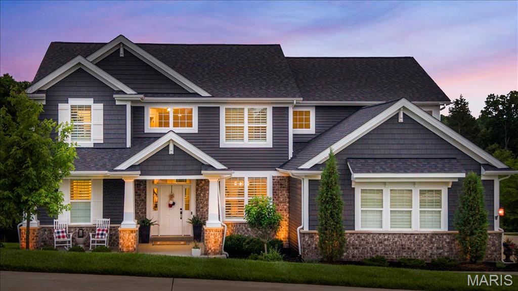 Step into a masterpiece where soaring ceilings and an expansive open floor plan breathe life into every corner. This 1.5-story Payne Family home, crafted in 2020, proves you truly can have it all - the privacy of an ACRE LOT with lush green views AND the fun of neighbors and the golf course nearby, too! Just off the foyer, the formal dining room showcases a beautiful tray ceiling, creating the perfect setting for holiday gatherings and special occasions. The kitchen is the heart of the home, anchored by a gorgeous oversized island that begs for morning coffee and evening hors d'oeuvres. Natural light pours through tinted rear windows and elegant transom accents, illuminating the rich engineered wood flooring and stunning 8-foot two-panel doors found throughout the home. The adjoining great room is anchored by a full-height stone fireplace plus trendy lighting and dramatic ceilings that make the space feel both grand and inviting. Shutters on the front and sides of the home add timeless style and privacy. Retreat to the main-floor primary suite, a sanctuary of calm and function featuring two vanities, a separate showing & soaking tub, and spacious walk-in closet. Another bedroom on the main level serves perfectly as a flex room, nursery, or office. Everyday convenience shines with the spacious main-floor laundry and nearby mudroom with custom bench & storage solutions. Upstairs, a sprawling loft space offers rooms to unwind plus three additional bedrooms, including a charming ensuite, and an additional hall bath. The unfinished walk-out lower level offers incredible future potential with doors leading to the back patio, plumbing rough-in for a future bath, and multiple egress windows that flood the space with sunshine - ready for your vision whether it’s a home theater, gym, guest suite, or additional entertaining space. The magic continues outdoors! Whether you’re sipping on the composite covered deck featuring new sun shades, grilling in the outdoor kitchen on a hot summer day, or roasting marshmallows by the built-in fire pit this fall season, this setup is the gold standard of entertaining. New landscape lighting installed in 2025 further elevates the curb appeal and evening ambiance.
Additional highlights include a NEW roof in 2024, dual HVAC systems for efficient comfort, and a built-in pest shield system for added peace of mind.
Located in the gated community of Pevely Farms in the Rockwood School District with quick access to Hwy 44, this one won’t last long! It’s the kind of home that turns “just looking” into “where do we sign?!” Schedule your showing today!