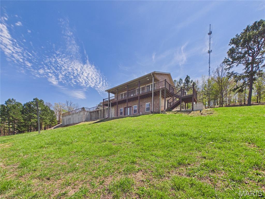Experience the pinnacle of Ozark living at 353 Skyline Drive. This commanding brick estate sits on nearly 6 acres of pristine ridge top land, offering a front row seat to the most spectacular views in Southern Missouri. From the comfort of your covered front composite deck, you will witness golden sunrises over the Current River valley and vibrant sunsets dipping behind the Ozark Mountains.

Inside, a complete renovation blends timeless elegance with modern luxury, featuring custom cabinetry, granite countertops, and rich hardwood floors. The property borders the natural corridor to Big Spring National Park, ensuring frequent visits from local wildlife. With a basement safe room, kitchenette potential, and enough acreage for a second build site or Bed and Breakfast venture, this is not just a home; it is a rare hilltop sanctuary.