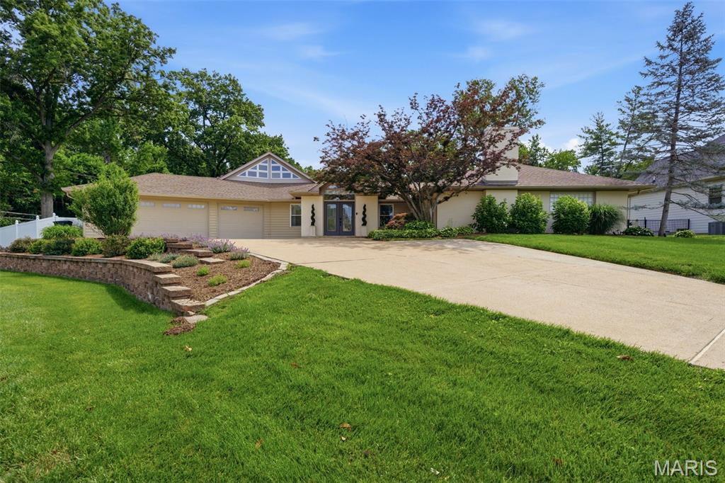 Nestled on a private, park-like lot of more than one-half acre backing to the wooded beauty of Stacy Park, this exceptional ranch offers a rare blend of luxury, privacy, and resort-style living in the highly acclaimed Ladue School District. With over 4,100 square feet of living space (appraiser verified), 4 bedrooms, and 3.5 baths, this remarkable home is tucked away at the end of a quiet cul-de-sac in one of the area's most desirable neighborhoods. Thoughtfully updated throughout, the home features elegant formal living spaces, a gourmet kitchen with custom cabinetry, premium countertops, and high-end appliances, plus an inviting family room designed for everyday living and entertaining. A sun-filled gathering room showcases panoramic views of the spectacular backyard retreat and pool. The luxurious primary suite includes a fireplace, walk-in closet, and beautifully renovated bath with dual vanities and an oversized walk-in shower. Two additional bedrooms share a full bath, while a separate fourth bedroom and full bath provide ideal accommodations for guests, a private office, or multigenerational living. The finished lower level offers flexible space for recreation, fitness, or home office and includes a temperature-controlled wine cellar, abundant storage, and a large Fort Knox safe. A second-floor loft overlooking the family room provides additional space for a home office, study area, or gym. Outdoor living is truly exceptional, featuring a resort-inspired pool, 24' x 30' covered outdoor living room with dry bar and television, built-in fire pit, hot tub, whole-home and outdoor sound system, and breathtaking wooded views. Additional amenities include an oversized finished three-car garage with epoxy floors, custom storage, with dedicated heating and cooling. A rare opportunity to own a one-of-a-kind property that perfectly combines luxury, recreation, privacy, and everyday comfort at 17 Stacy Drive.