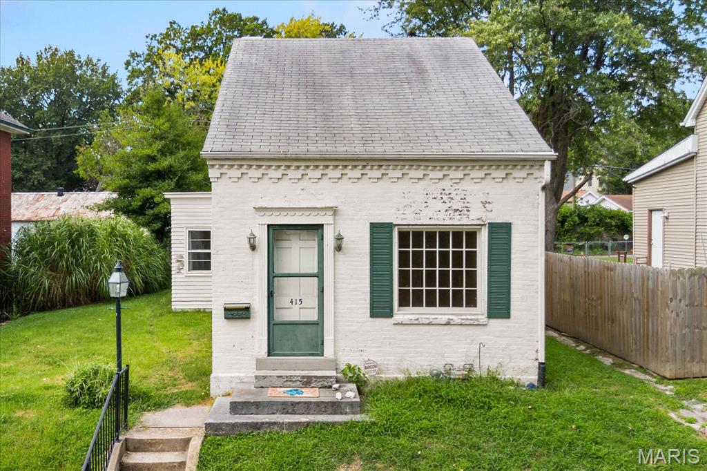 This charming home offers great bones, a functional layout, and plenty of potential for the investor or buyer looking to bring their vision to life. Beautiful hardwood flooring adds character to the spacious living and dining rooms, while the large kitchen offers tons of cabinetry and a convenient nearby breakfast nook. The main level features a good-sized bedroom, bonus room, and main-floor laundry for added convenience. Upstairs, a lovely second bedroom showcases a unique beamed ceiling and beamed ceiling detail. Outside, the detached two-car garage provides valuable parking and storage space. Located in the heart of Belleville, this home is ready for someone to unlock its potential.