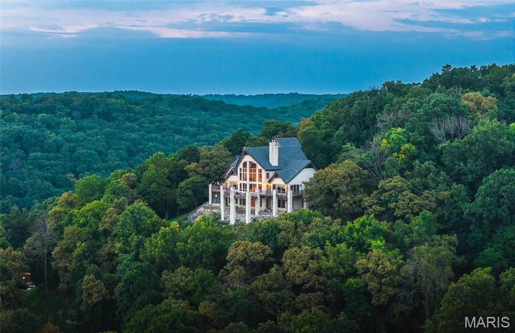 1 River Ridge is a modern stone Chateau located in Grafton, Illinois.  The estate rests on almost 5 secluded acres overlooking the confluence of the Illinois and Mississippi Rivers. This well documented executive build hovers over the Great River Road and provides arguably the most prolific panoramic view of the Mississippi River in North America. 
 Located 30 minutes from a world class private air facility and 35 minutes from St. Louis International Airport. Less than 5 minutes to Grafton Harbor, a full service strategic Looper friendly marina. Primary or second home living, the true definition of a "Getaway".