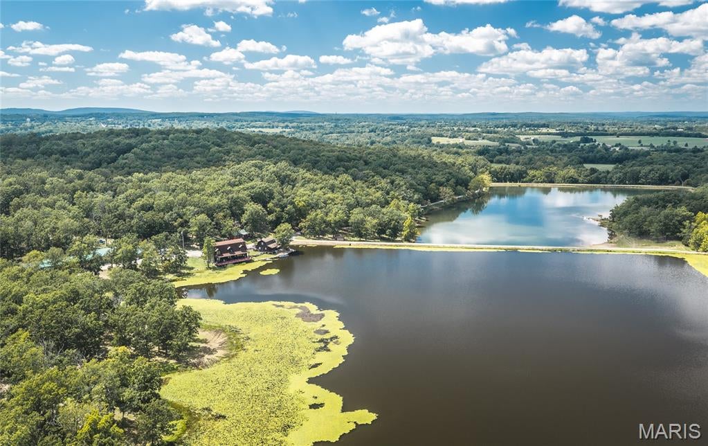 An exceptional 847 +/- acre world-class whitetail hunting preserve in Bismarck, Missouri, offering a rare combination of premier hunting habitat, world-class genetics, stocked lakes, quality improvements, and turnkey infrastructure. This is an extraordinary opportunity to own one of the premier whitetail hunting properties in the Midwest. The property features two stocked lakes, creating a beautiful setting for recreation and wildlife while providing an incredible backdrop for the 3,600 sq. ft. lakefront main lodge. The lodge offers 3 bedrooms, 3 bathrooms, and a spacious waterfront deck, making it the perfect gathering place after a day in the field. Two additional guest cabins provide comfortable accommodations for hunters, family, friends, or corporate clients. The ranch is fully equipped to support a professional hunting operation, featuring a 40' x 60' shop with office space and garage doors, a dedicated skinning shed with walk-in freezer, and a massive 30' x 90' utility building with individual stalls for equipment, storage, and operational needs. The existing whitetail genetics are among the best in the country, with several exceptional bucks reportedly exceeding 300 to 400+ inches. The combination of genetics, high fencing, established infrastructure, and expansive acreage creates an ultimate setting for a premier deer hunting facility, private preserve, or exclusive destination for friends, family, and corporate clients. In addition to its world-class whitetail program, the ranch boasts an amazing turkey population, offering outstanding opportunities to chase Missouri's hard-gobbling spring toms. Twin Lake Whitetail Property is a once-in-a-lifetime opportunity to own one of the finest whitetail hunting properties in all of the Midwest. From the exceptional genetics and high-fenced preserve to the two stocked lakes, lakefront lodge, guest cabins, and extensive operational improvements, this property is truly in a class of its own. Call today to schedule a private tour of this exceptional hunting and outdoor gem.