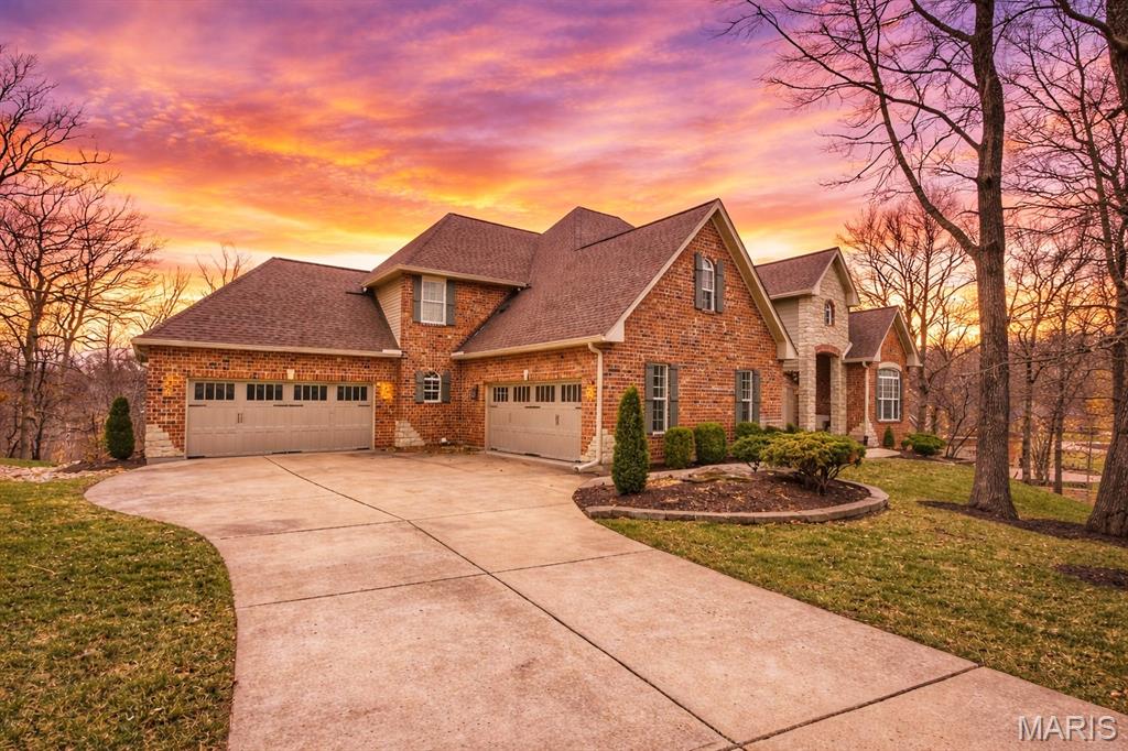 Sprawling custom estate on an ultra rare 3+ acre private lot in the Legends Golf Community! Dramatic & elegant curb appeal with full brick & stone front elevation, 2 separate & oversized 2 car garages, sweeping roofline with architectural shingles (new in ‘23) & mature, easy to maintain landscaping w sprinkler system. Walk up to a 2 story entryway with large stone pillars & into a spacious, open floor-plan with high ceilings, wood flooring throughout, neutral colors & over 5,000 square feet of living space. Formal living room is improved with crown molding & can easily serve as your home office. Formal dining room can accommodate even the largest furniture for holiday entertaining. 2 story great room is adorned with a full rear wall of atrium windows overlooking nature, recessed lighting & gas FP. Gourmet, eat in kitchen is improved w/42 inch custom cabinets, granite counters, wall oven/micro, subway tile backsplash, gas cooktop, center island/breakfast bar, wet bar, dining area, hearth room, 2nd gas FP w/brick accent wall & full laundry room. Main floor MB suite includes a luxury master bath with jetted tub, glass shower enclosure, his/her vanities, custom fixtures & large walk in closet. Upstairs is a useful den area, 3 spacious bedrooms & 2 full baths. Walk-out LL partially finished in 2025 with stained concrete flooring, recreational/living space, plentiful storage, numerous windows & walk out access. Out back is a wood deck & large concrete patio overlooking a picturesque & private lot surrounded by natural foliage. Walking distance to the Legends Country Club, just a golf cart ride away from dining & shopping in downtown Eureka, numerous neighborhoods amenities & more!