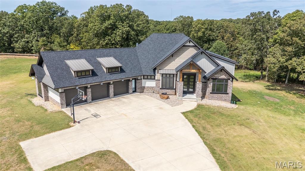 Welcome to a true luxury retreat! This one-of-a-kind custom-built estate showcases 6 bedrooms and 4.5 bathrooms, thoughtfully designed with elegance and comfort in mind. Situated on 29 (+/-) private acres, the property blends modern sophistication with serene country living. As you enter, you’ll be captivated by soaring 15-foot ceilings and walls of windows that flood the home with natural light.  Rich finishes and gas fireplaces create warmth and sophistication, while the open-concept floor plan is designed for both grand entertaining and everyday living. The gourmet kitchen is a chef’s dream, featuring Viking appliances, a massive island, custom cabinetry, and a seamless flow into the living and dining areas. The master suite is truly a retreat of its own, offering a spacious bedroom, spa-inspired bathroom with heated floors, soaking tub, and a tile shower. The oversized walk-in closet is complete with a custom center island. Downstairs, the fully finished walkout basement offers endless possibilities. A second kitchen, hidden safe room, large living areas, and even a built-in slide connecting the main level make this space as fun as it is functional. With a geothermal system for efficiency and an abundance of high-end features throughout, this estate is as practical as it is stunning. This property is more than just a home—it’s an experience, offering luxury, creativity, and comfort all in one breathtaking package.  Call today, before gone tomorrow!!