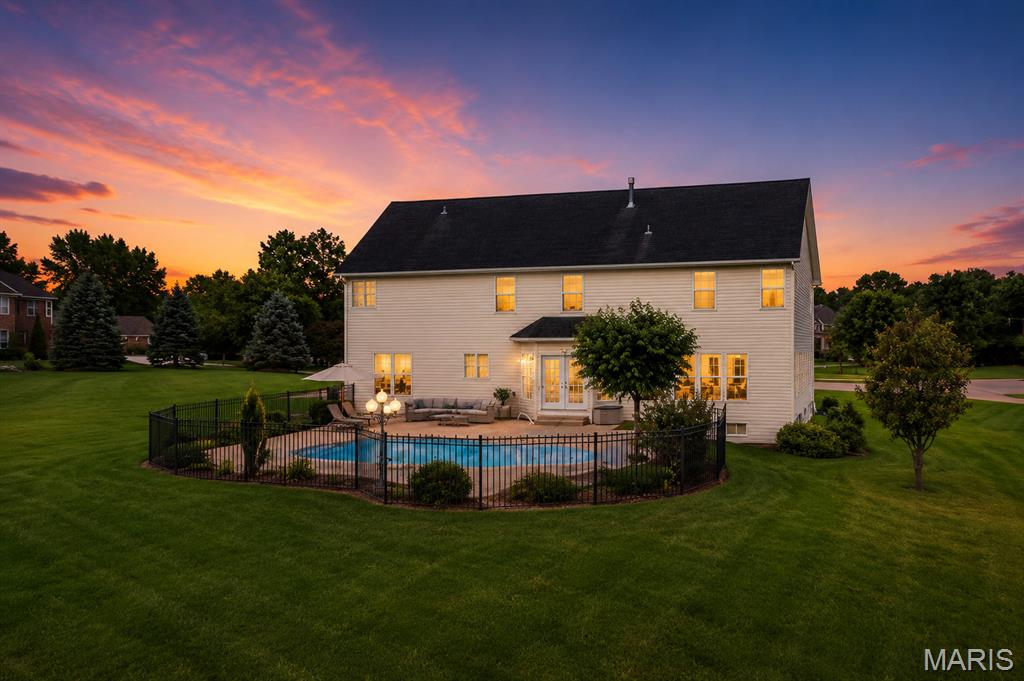 Some homes are built to impress. Others are built to be lived in. 371 Galahad Court is both. Gracefully positioned on a private one-acre homesite within Camelot—one of Weldon Spring's most distinguished communities—this elegant brick-and-stone estate offers a lifestyle rarely found in today's market. Situated on a quiet double cul-de-sac surrounded by mature trees, lakes, and walking trails, the home combines timeless architecture with exceptional privacy while remaining just minutes from Chesterfield Valley, premier shopping, fine dining, hospitals, and major employers. Inside, nearly 6,000 square feet of beautifully finished living space unfolds with soaring ceilings, rich hardwood flooring, custom millwork, and walls of windows that fill the home with natural light. The heart of the home is an inviting chef's kitchen designed for both everyday living and memorable gatherings. It flows effortlessly into the breakfast room, great room, and outdoor entertaining areas, creating spaces where family and friends naturally come together. Outside, your own private resort awaits. The sparkling in-ground pool, expansive patio, professionally landscaped grounds, and fully fenced backyard create an atmosphere more reminiscent of a luxury retreat than a suburban home. Whether hosting summer celebrations, holiday gatherings, or simply enjoying a quiet evening under the stars, every season becomes an opportunity to create lasting memories. Upstairs, the luxurious primary suite serves as a peaceful sanctuary, complete with a fireplace, spa-inspired bath, and an extraordinary walk-in closet with custom cabinetry and coffee bar—an everyday indulgence rarely found even in luxury homes. The finished lower level extends the home's versatility with generous recreation space, entertaining bar, full bath, and guest accommodations, making it equally suited for multigenerational living, overnight guests, or game-day entertaining. Beyond the home itself lies one of St. Charles County's most sought-after neighborhoods. Camelot is celebrated for its scenic lakes, winding walking trails, spacious estate lots, and enduring sense of community. Opportunities to own a one-acre property of this caliber in such an established neighborhood are increasingly uncommon. This is more than a beautiful home. It is a place where holidays are celebrated, grandchildren gather, lifelong friendships grow, and memories are made for generations. Welcome to 371 Galahad Court. Where exceptional living begins.