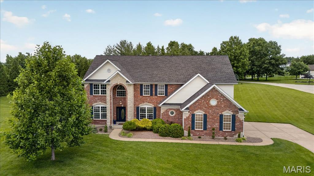 Located in one of the area’s most prestigious and highly sought-after neighborhoods, this exceptional brick-and-stone home offers an unmatched combination of elegance, privacy, and lifestyle. Gracefully set on a private one-acre lot within a quiet double cul-de-sac, the home is located in the prestigious Camelot community, known for its scenic lakes and winding walking trails. Inside, rich oak hardwood floors and detailed millwork create a warm yet sophisticated atmosphere. The designer kitchen, featuring 42-inch cabinetry, granite countertops, a generous center island, and a planning center, serves as the heart of the home, designed for both everyday living and gracious entertaining. The sun-filled breakfast room opens through French doors to the patio and pool, offering effortless indoor-outdoor living throughout the seasons. Outside, the resort-style pool is thoughtfully equipped with remote-controlled features, including lighting, a fountain, and an automatic vacuum system for easy maintenance and elevated enjoyment. A basketball hoop near the stair area adds an extra touch of recreation and fun to the outdoor space. The dramatic great room showcases a wall of windows and a marble fireplace flanked by built-ins, creating a welcoming space to gather. A private study provides flexibility for a home office or guest suite. The coffered primary suite is a true retreat, complete with its own fireplace, an expansive 14-foot walk-in closet featuring a built-in coffee bar and cabinetry, and a spa-inspired bath with dual vanities and a jetted tub. The finished lower level expands the home’s versatility with a recreation room, gathering bar, and additional accommodations, including a full bath, ideal for hosting, relaxing, or accommodating guests. Set within a neighborhood celebrated for its tranquil lakes, walking paths, and strong sense of community, this home offers not only luxury, but a lifestyle defined by connection, comfort, and prestige.