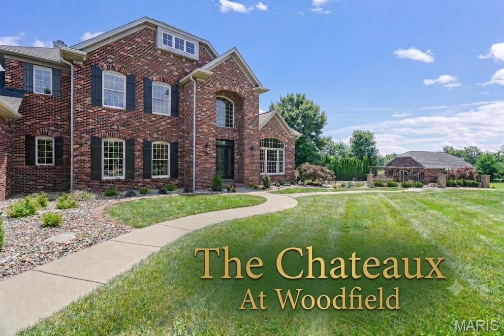 Exceptional custom luxury residence situated on a premier homesite in the prestigious Chateaux at Woodfield. This impressive home offers a thoughtfully designed floor plan with soaring ceilings, rich hardwood flooring, extensive custom millwork, elegant Italian stone flooring, a dramatic open staircase, and a stunning two-story great room filled with natural light. The gourmet chef's kitchen features granite countertops, premium cabinetry, generous prep space, and seamless flow into the breakfast room and inviting hearth room.

Entertain with ease in the formal dining room, wet bar area, expansive deck, professionally designed home theater with cinema seating, and spacious game room. The luxurious primary suite serves as a private retreat with a spa-inspired bath and custom walk-in closets.

Additional features include a private office, ensuite bedrooms, dedicated fitness room with steam shower, floor-specific HVAC zoning for enhanced comfort and efficiency, irrigation system, and abundant storage throughout. Extensive recent updates include new roofs (2025), fresh designer paint, premium new carpeting, and custom cellular shades throughout, enhancing both comfort and style while providing true turnkey luxury living.

A rare opportunity exists to purchase the adjacent improved homesite, offering exceptional flexibility for multigenerational living, extended guest accommodations, a private office or studio, or resort-style entertaining. The neighboring property features a substantial guest residence, custom pool, outdoor kitchen, and beautifully designed outdoor living spaces and may be purchased separately or in conjunction with this home, subject to availability. This property is listed separately on MLS # 26035971.

Located within the prestigious Chateaux at Woodfield, this exceptional property offers timeless architecture, outstanding craftsmanship, and luxury living at its finest.
