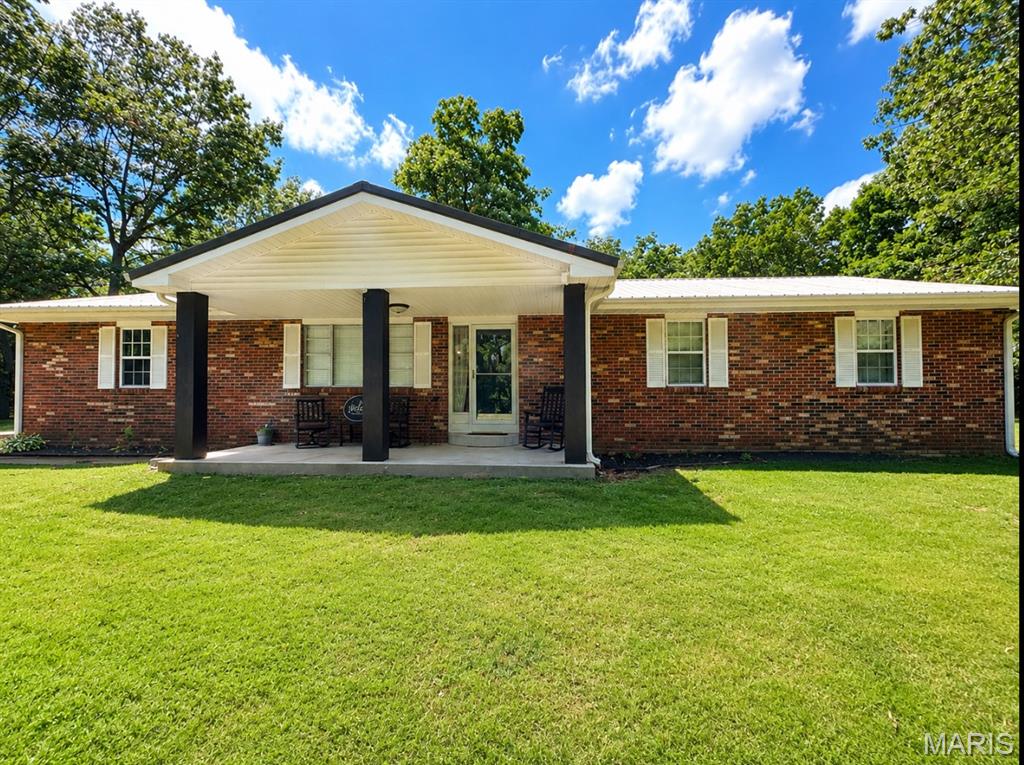 The feel of the country just minutes from town!!  This 3-bedroom, 2.5-bath all-electric home offers approximately 1,700 sq. ft. of living space plus a 230 sq. ft. sunroom, all on one level.  All electric home, central heat and air, attached garage, a 22x30 detached metal building, and an in-ground pool with pool house. Situated on 3 acres m/l with mature shade trees, a fenced backyard, paved road access, and an excellent location close to town!!