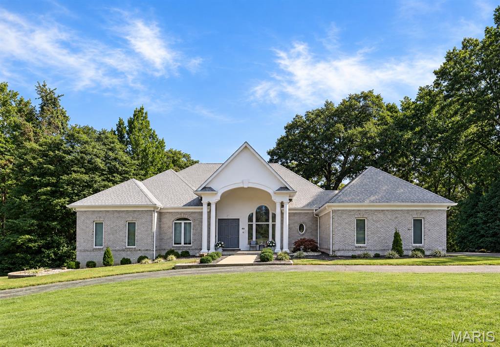 WELCOME TO KINGS POINTE!! LUXURY LIVING IN THE METRO EAST!!
Set at the end of a peaceful cul de sac, 46 Kings Pointe Court is a distinctive brick atrium ranch offering 4 bedrooms, 6 bathrooms, approximately 4,563 square feet of living space, and nearly an acre of privacy. Mature trees, established landscaping, and a peaceful tree lined setting create a sense of seclusion while providing beautiful views throughout the home.

The architecture makes an impression, but the rare floor plan is what makes this home memorable. It is open without losing definition between rooms, spacious without feeling disconnected, and filled with natural light. Beautiful windows take advantage of the setting, keeping the surrounding greenery present throughout the home.

The beautiful formal dining room brings its own character to the home with a large window that fills the space with natural light and custom wallpaper that gives the room a polished, distinctive finish. It is a dining room meant to be enjoyed, whether hosting holidays, intimate dinners, or special gatherings.

The generously sized kitchen was built to accommodate a home of this scale, offering a center island, abundant cabinetry, workspace, a pantry, beautiful lighting, and plenty of room for everyone to gather comfortably.

Privacy was clearly considered in the bedroom design, with every bedroom having bathroom access. The main level primary suite is a retreat of its own with a custom closet, private deck access, and a beautiful bath centered around a stand-alone soaking tub, creating the feeling of your own spa oasis.

The wraparound deck adds another dimension to the home, extending the living space outdoors and surrounding you with mature trees and greenery. The sauna is located on the deck and stays with the home, providing another place to unwind while enjoying the peaceful, private setting.

The atrium design truly comes to life in the finished walkout lower level. Large windows bring in beautiful natural light, allowing this level to feel like a continuation of the home rather than a traditional basement. A second primary suite with its own deck access creates an exceptional option for an in-law suite, extended family, overnight guests, or a private retreat. A spacious family room, wet bar, exercise area, half bath, and additional storage complete this versatile level.

Thoughtful updates and maintenance include a new roof in 2023, Leaf Guard gutter protection around the entire home, updated LED lighting throughout, newer kitchen appliances, washer and dryer, water softener, and an Aroma360 Museum360 whole home scenting system. An attached 3 car garage adds even more convenience.

**What makes Kings Pointe Court special is how everything comes together** The ease of ranch living, the character of a brick home, two primary suite options with deck access, a light filled walkout lower level, formal dining room, wraparound deck, sauna, nearly an acre of privacy, and a floor plan that is exceptionally hard to duplicate.

Schedule your private showing and make this unique home yours!