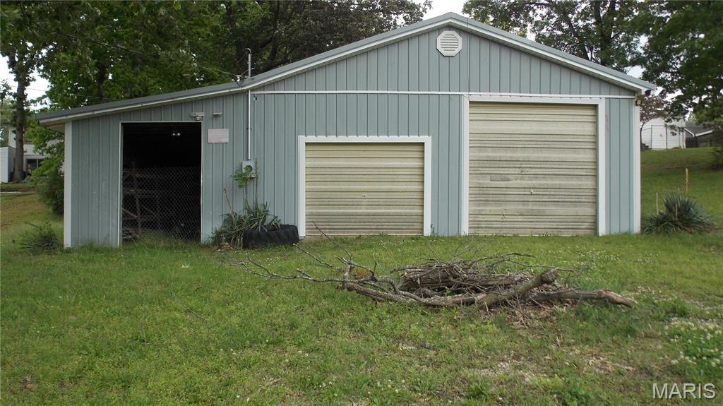 This is a 2-vehicle garage with 2 doors, one overhead. This building has been used as a private garage and wood workshop.