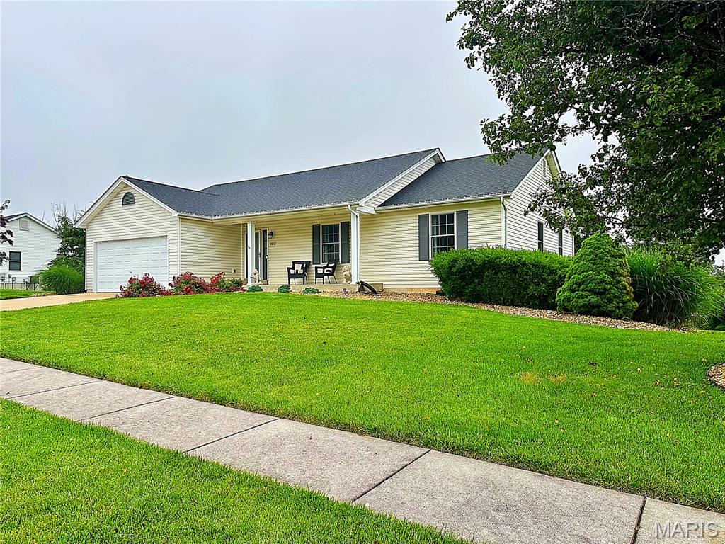 Prepare to be Blown Away!  This amazing Wentzville ranch home is nothing short of a Designer Showcase!!  As you enter the home the welcoming foyer, you see the beautiful wide plank AC4 Wear Layer Hybrid Flooring that is throughout the entire home! The Open floor plan leads you to the Cathedral ceiling Family Room with stunning custom molding throughout & wood burning fireplace, to the Dining area, then to the amazing kitchen featuring Granite counter tops, Breakfast bar, Stainless Steel Appliances, and Custom White cabinetry with puck lighting.  From the kitchen, you enter the Laundry mud room which leads to the oversized 2 car garage that will fit a full sized SUV.  Outside the dining area is a massive 22 X 14 custom deck with aluminum balusters & end caps with a staircase leading down to a nice covered concrete patio. To the living area is a very nicely updated guest bathroom, 2 nicely sized guest rooms, to the Master Suite with walk in closet, and bright Master Bath with Soaking tub, separate shower and vanity.  This amazing home sits on a nearly half acre lot with Landscaping to die for!  The Unfinished walk out lower level awaits you vision to make this home YOUR Paradise!