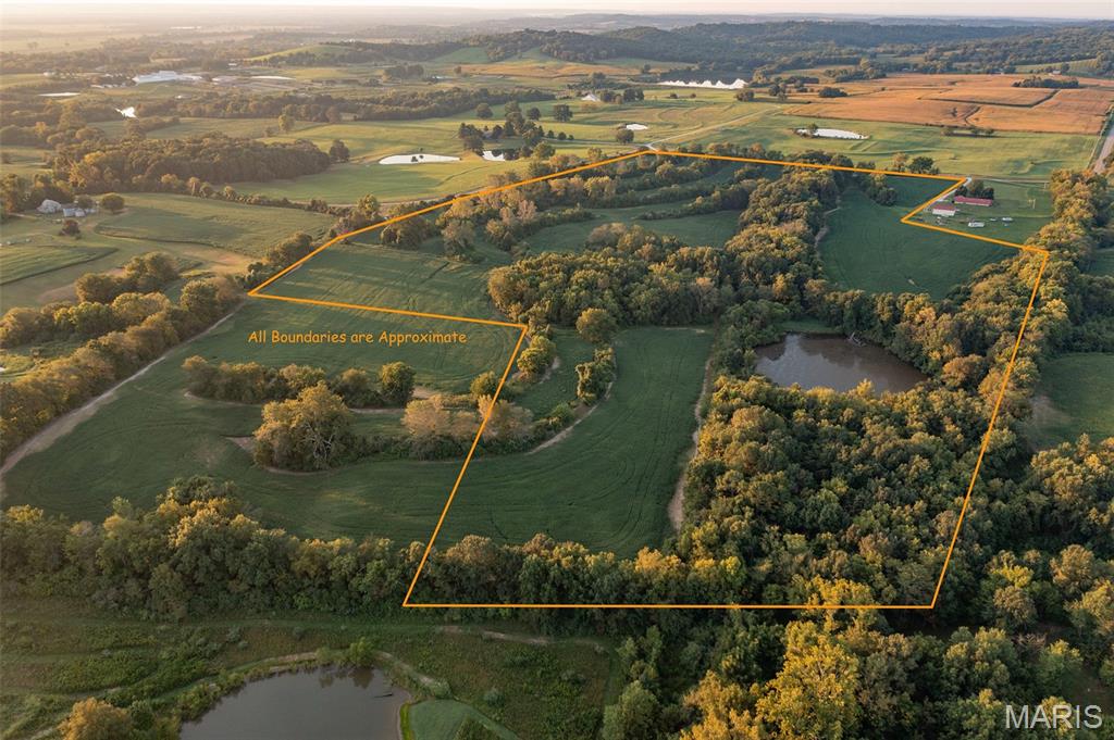 Discover the best of both worlds with 51.2 surveyed acres just outside Elsberry, Missouri, offering an exceptional combination of productive tillable ground, recreational acreage, and an ideal homesite. Approximately 30 acres are tillable, providing income-producing potential while the balance of the property offers excellent opportunities for hunting, recreation, and enjoying the outdoors.

One standout feature of this property is the beautiful northern view overlooking the Elsberry Knobs. The relatively level terrain creates an excellent setting for building a home while allowing you to take advantage of the surrounding countryside and scenic views.

For those looking for recreational opportunities, this property delivers. Deer and turkey are abundant, and waterfowl periodically utilize the approximately 1-acre watershed lake located on the property. The lake provides a unique opportunity to attract and harvest multiple species of wildlife while adding to the overall recreational appeal of the farm.

Another rare benefit is the potential access to public water and a septic system. The estimated cost for a tap is around $4,500.

Whether you're looking for a place to build your dream home, add acreage to your farming operation, establish a recreational property, or simply invest in land with multiple potential uses, 00 Hwy JJ offers a rare combination of tillable ground, wildlife, water, scenic views, and building potential in a convenient location just outside Elsberry.