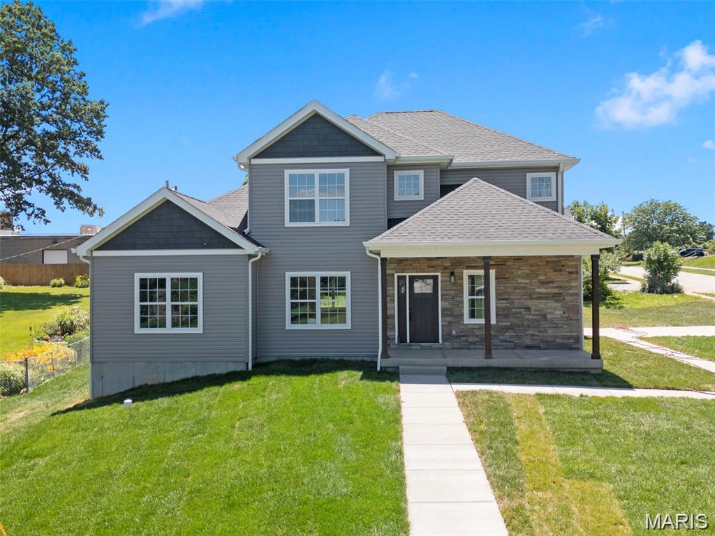 Welcome to this exquisite custom-built 1.5-story home offering over 2,349 SQFT of beautifully designed living space in the highly sought-after Rockwood School District. Situated on a .43-acre corner lot, this home blends modern luxury with everyday comfort.

Step inside to soaring 9’ ceilings, warm luxury vinyl plank flooring, and an open layout perfect for entertaining. The chef’s kitchen is the heart of the home, featuring 42" white cabinetry, Quartz countertops, a striking Mocha island, stainless steel appliances, pendulum lighting, and a refrigerator with ice maker. The family room offers a cozy recessed electric fireplace and abundant natural light.

The main-level primary suite is a true retreat with a 17x14 bedroom, walk-in closet with custom built-ins, and a spa-inspired bath complete with soaking tub, walk-in shower, and dual vanities. A dining room, guest bath, mud room, and main-floor laundry add convenience.

Upstairs, guests will enjoy a private bedroom with full bath, while two additional bedrooms share a beautifully finished hallway bath. Ceramic tile, adult-height vanities, and thoughtful design elevate every space.

Outside, relax on the covered porch or entertain on the patio. The side-entry garage includes an EV charging station. Dual-zone HVAC and a full basement provide comfort and future potential. This home is truly move-in ready and designed for modern living.