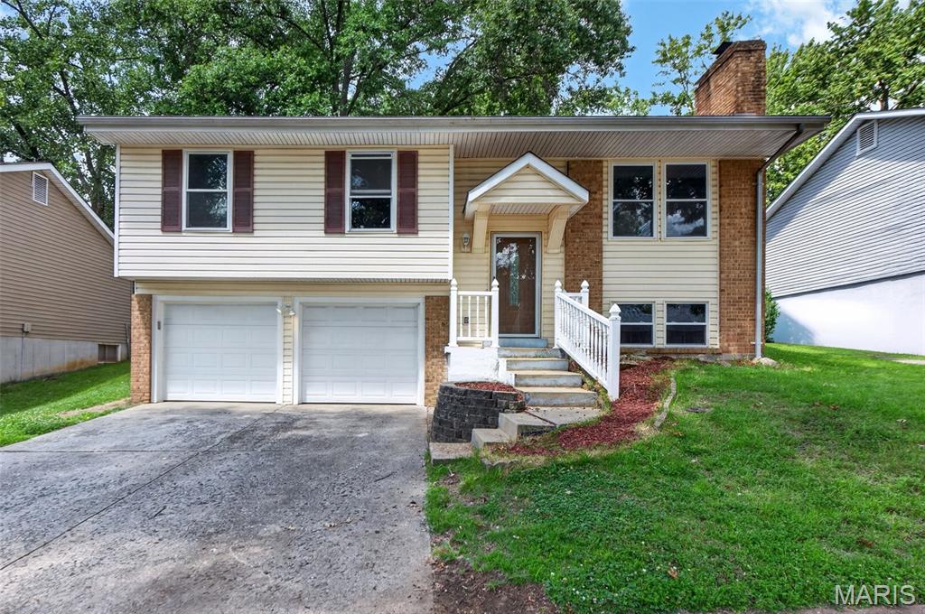 Welcome to this beautifully maintained split-foyer home offering the perfect blend of comfort, space, and timeless appeal. Nestled on a generous, tree-lined lot, this inviting residence features bright, open living spaces enhanced by abundant natural light and beautiful hardwood flooring throughout the main level.

The spacious living room flows seamlessly into the formal dining area, creating an ideal setting for both everyday living and entertaining. The kitchen offers an abundance of crisp white cabinetry, ample counter space, and stainless steel appliances, providing both functionality and style.

Three comfortable bedrooms and a well-appointed full bath complete the main level, while the finished lower-level family room offers a warm and versatile retreat—perfect for movie nights, a recreation area, home office, or playroom.
Step outside to enjoy the expansive backyard shaded by mature trees, offering endless possibilities for outdoor entertaining, gardening, or simply relaxing in your own private oasis.
Conveniently located near parks, shopping, dining, schools, and major highways, this home combines peaceful neighborhood living with everyday convenience. Move-in ready and filled with potential, 2311 Country Village is ready to welcome you home.