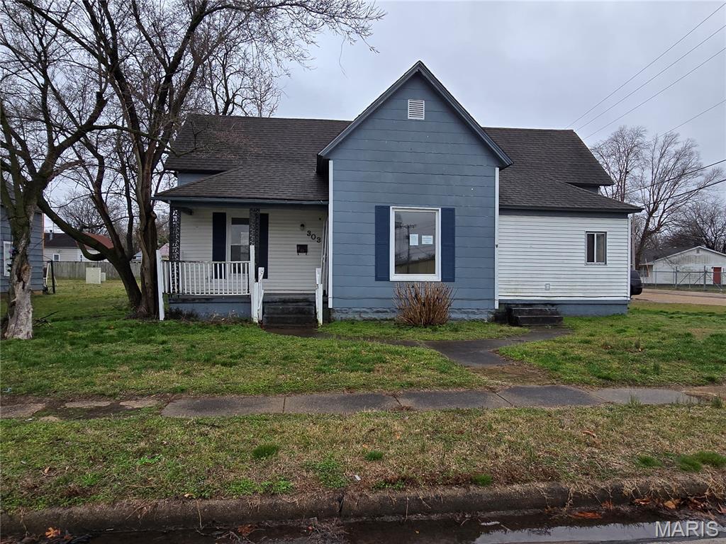 Are you ready for a small home in Sikeston?  You can sit on the covered, front porch and enjoy a morning cup of coffee while watching others out and about!  This Bungalow-style home boasts of 3 bedrooms, 1 bathroom, an eat-in kitchen, a covered carport in back yard all located on a corner lot.  The kitchen has several cabinets, an island along the wall, and a range and a dishwasher included.  It's within walking distance of restaurants, shopping, and convenience stores.  It has a split floor plan.  Ceiling fans in the kitchen and bedrooms.  6-panels doors throughout.  Carpet and laminate in most of home with linoleum in bathroom.  The bathtub has a surround shower/tub unit and a single vanity.  Washer/Dryer hookups in corner of kitchen.  It appears to have vinyl windows throughout.  Small yard perfect for mowing quickly.  Priced to sell, so don't wait for your opportunity to purchase an affordable home.