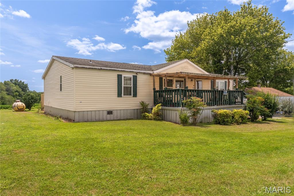 Escape to peaceful three bedroom country living at 8215 State Route 146, Buncombe, Illinois! This charming relocated manufactured home offers a fresh start on a spacious lot surrounded by beautiful open farmland and countryside views. Built in 2007, the home sits privately along the route 146  in a serene setting perfect for those seeking tranquility and space. 

Key Features:Open & Airy Setting — Enjoy wide-open spaces all around with room to breathe, garden, or simply relax and watch the seasons change in this quiet farm town.
Storm-Ready Detached Building — A practical outbuilding includes a basement, providing reliable shelter and extra storage or workshop space.
Convenient Location — Nestled in Buncombe, a peaceful small farm community in Johnson County, just a short drive (about 8 miles / 10-11 minutes) outside Vienna. You'll appreciate the rural charm while staying close to local amenities, trails, and the natural beauty of Southern Illinois. 

Whether you're looking for a primary residence, weekend retreat, or investment property with room to expand, this home delivers affordable country living with modern construction roots. Imagine mornings with coffee on the property, evenings under clear skies, and the freedom that comes with acreage in a low-key community.