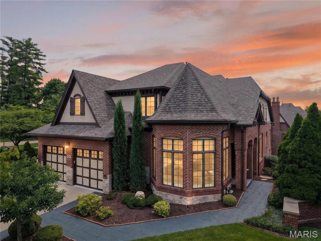 Stunning 1.5-story brick home in the highly coveted, gated community of August Hill off Conway Road. Designed for refined living and effortless entertaining, this residence blends timeless architecture with sophisticated finishes throughout.

An eye-catching reverse-vaulted great room welcomes you with rich hardwood floors and a sleek gas fireplace, flowing seamlessly into an impressive chef’s kitchen outfitted with Sub-Zero and Wolf appliances, custom cabinetry, and abundant counter space. The adjacent breakfast room offers a cozy, light-filled space that opens to a private terrace overlooking the tranquil, tree-lined backyard.

The main-floor primary suite is a serene retreat, featuring a bright bay window, hardwood floors, and a spa-inspired luxury bath with premium finishes and generous storage. Upstairs, two spacious ensuite bedrooms and an airy loft overlook the great room, providing ideal secondary living and guest spaces.

The beautifully finished lower level is designed for entertaining, showcasing a generous family room, gaming area, guest suite with full bath, and access to a screened patio for indoor-outdoor enjoyment. A full sit-down bar elevates the space, complete with custom cabinetry, dishwasher, wine refrigerator, and full-size refrigerator—perfect for hosting gatherings in style.

Offering privacy, security, and exceptional craftsmanship in one of the area’s most desirable gated enclaves, this August Hill home is a rare opportunity for the discerning buyer.

Note: **New Pella windows are on order for most of the home. **Most furnishings, excluding art collection, is negotiable.