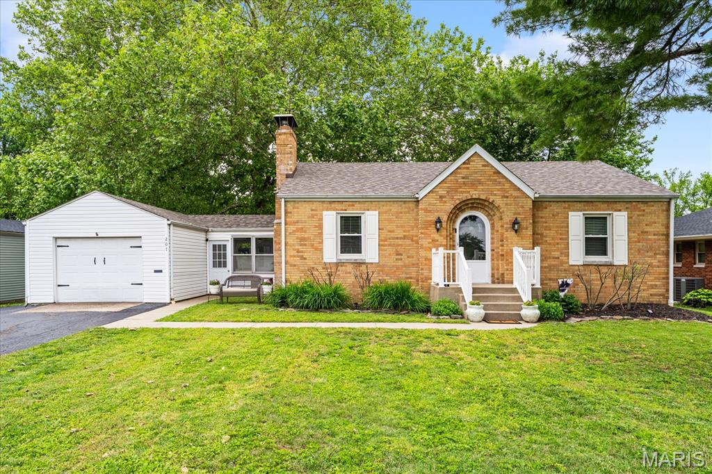 Charming and beautifully updated, this mostly brick ranch in desirable O'Fallon offers the perfect blend of classic character, modern updates, and functional living space. This move-in ready 3-bedroom, 2-bath home features a stunning custom eat-in kitchen with granite countertops, soft-close cabinetry, stainless-steel appliances, and ample space for cooking and entertaining.  The main level showcases hardwood floors throughout the living room and two bedrooms, creating a warm and inviting feel. The spacious living room is highlighted by a cozy gas fireplace, while the updated full bath features stylish finishes and a charming barn door entry for added character. The finished lower level provides incredible additional living space with a large family room and bar area perfect for entertaining, movie nights, or game day gatherings. The oversized lower-level bedroom with egress window and adjoining full bath with double vanity and tub/shower combo creates an ideal private primary suite or guest retreat. Additional lower-level storage, utility, and laundry areas add even more convenience. Just off the kitchen, the breezeway leads to the attached one-car garage with extra storage space. Step outside to enjoy the massive fenced backyard with patio, ideal for outdoor activities. Conveniently located near parks, shopping, dining, and schools, this beautifully maintained home offers comfort, space, and value in a fantastic location.  Schedule your showing today!