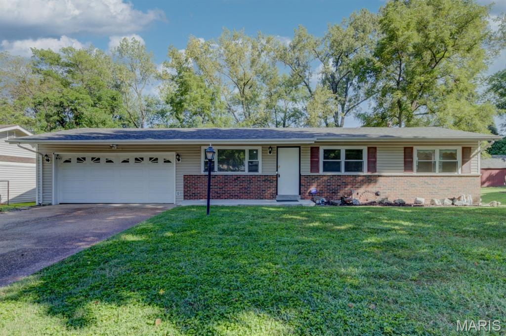 Incredible rare opportunity to own a spectacular 0.817-acre level, fenced lot backing to mature trees, with a large composite deck and adjoining patio creating exceptional space for entertaining and recreation. An extended bonus 2nd driveway (50 amp outlet available) provides abundant off-street parking at the end of a quiet dead-end street, complemented by two versatile bonus sheds. The low-maintenance exterior features insulated vinyl siding, brick front, enclosed soffits/fascia, upgraded architectural roof 2026, thermal windows, HVAC 2018, updated 200-amp electric panel and exterior mast plus an oversized 520-square foot garage with subpanel & newer overhead door. Inside, the main level offers fresh neutral paint, beautiful wood floors, six-panel doors, crown molding, attic fan, refreshed baths and an inviting living room with large picture window. The spacious eat-in kitchen features white cabinetry, faux-stone counters, double sink with gooseneck faucet, stainless steel range and dishwasher, recessed lighting and a Anderson sliding door w/retractable screen opening to the incredible outdoor living space. The primary suite includes mirrored closet doors, fabric shades and a private half bath. Finished basement provides abundant additional living space plus generous storage. High-rated Pattonville Schools & home warranty included. A truly special property offering privacy, versatility and a lifestyle to enjoy every day—proudly owned and lovingly maintained by the current owner for 53 years!