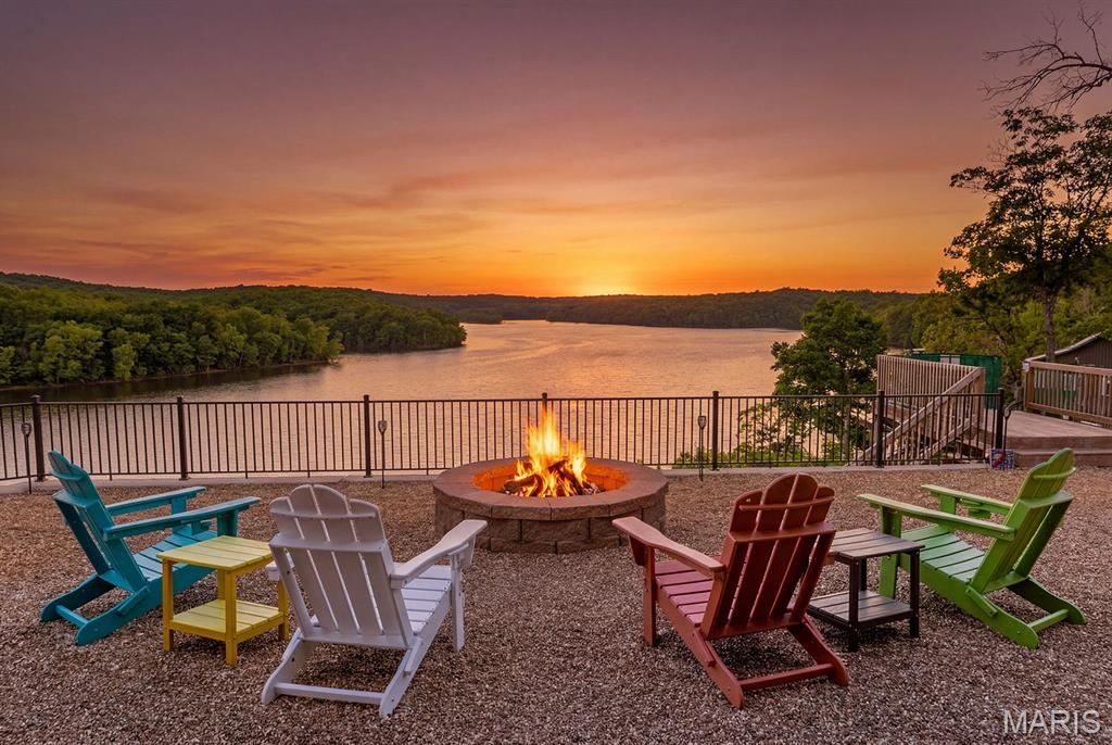 What a VIEW! Tucked in a private setting, but with the convenience of being 20 minutes to Warsaw or Lincoln, this property has it all! Featuring main level living with primary suite, open living, inviting kitchen, and views out the back to make your dreams of a peaceful lake lifestyle come true. In the full, finished basement you'll find another living area, 2 bedrooms and another full bath with all windows viewing the water. Watch the bald eagles in your back and front yards, enjoy the firepit with a view, and an easy tram ride (With a MAX weight of 800 lbs) down to the 2-well dock which has been serviced every year and functions smoothly and quietly to help you get down to the water with ease. Owners have also added an RV hookup for those friends and family who come with their own space...or for overflow when you have those big gatherings with friends and family. With just over 1 acre (2 separate parcels at around .5 acres each) you have space to enjoy your yard and home, plus room to build a shop, cabin, or build a 2nd tier home to sell...AND you're close to the Brickley Hollow Conservation area for more nature and fun...your options are limitless! Call today to get more information and to schedule a showing!