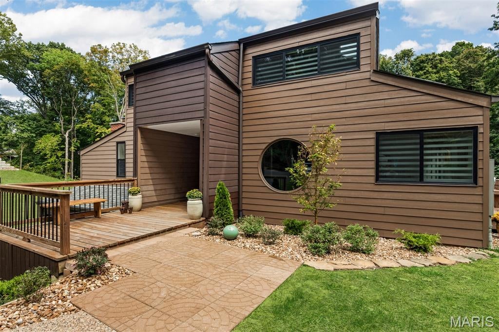 Rare opportunity to own a piece of St. Louis architectural history with an extraordinary private lakefront lifestyle. Designed and built in 1974 by renowned St. Louis architect Tom Hall as his personal residence, this one-of-a-kind Mid-Century Modern has been extensively renovated while thoughtfully preserving Hall's original design. Set on 3 wooded acres in gated Arrowhead Estates, the property overlooks a private, spring-fed lake with its own dock.
Walls of windows, skylights and Hall's signature circular windows fill the house with natural light and connect nearly every space to the surrounding woods and water. The open floor plan features three fireplaces, a dramatic Atrium, sunken conversation Den and custom wood screens inspired by the surrounding trees. Hall's original office—with private entrance, half bath and walls displaying his architectural blueprints—remains an extraordinary piece of the home's history.
The main-floor primary suite offers a fireplace, private lake-view balcony, ensuite remodeled bath and large walk-in closet with island. The kitchen and dining areas flow into the spacious family room with a floor-to-ceiling stone fireplace and sliding doors opening to lakeside decks. Upstairs are three generous sized bedrooms and beautifully remodeled baths.
Extensive improvements include a new roof, remodeled bathrooms and kitchen, plus significant updates to major systems—including electrical, water heater, filtration and extensive foam insulation—along with substantial exterior, drainage and landscaping improvements. See supplements for the complete improvement list.
Outside, 3 private wooded acres and a dock on the approximately 5-acre spring-fed lake create an exceptional setting for fishing, kayaking, paddle-boarding or simply enjoying the wildlife and views. Arrowhead Estates also offers tennis courts and a gated setting. Enjoy the feeling of a private retreat while remaining just minutes from Chesterfield Valley shopping, dining and entertainment, The District, The Factory, Faust Park/Butterfly House, groceries and Highway 40.
Architectural history, thoughtful renovation, privacy and a private lake—this is a property that simply cannot be replicated. This is a home that truly needs to be seen to be appreciated.