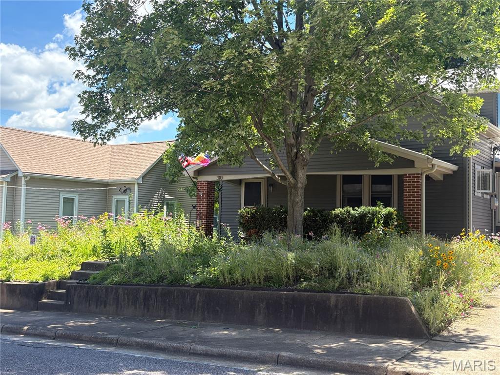 Love older homes but worried about the cost of updating to make it energy efficient? Check this out!!   All the BIG ticket items have been taken care of ! This home has a geothermal system(2009). If that is not enough to save energy, there are solar panels(2013) on the 2 car tandem garage(2013)  Yes, this garage will fit two vehicles and if they are electric, got that covered as well.  WAIT, there is more !!  Metal roof (2019) ALL new windows(2020) a throughout! Updated electric Panel (2007) Updated  copper pipes and water meter (2008).  Two hot water heaters and a water softener.
Now to the charm!  There are three bedrooms upstairs with a full bath and ample closet space.  The main level has a large living area, dining area, full kitchen, Bedroom and full bathroom.   It has plenty of space for everyone.   Now the outside- Retaining wall built in 2017, the front and side yards has been planted with all perennial native Missouri wildflowers, and are in second year so next year should be fantastic!  All that pollination !  Large covered front porch, driveway that leads to that super awesome garage and a side walk leading to the back patio.  The back yard is something to see.  Over 1/3 acre lot which is quite large for a home in the downtown Washington area.  The  patio that is partially covered and leads out to a large level back yard which is private and fully fenced.  Close to hospital, doctors, eateries, schools, churches, parks, playgrounds and shopping.   Always something to do with the River Trail, Sunset on the River Front, Wine Fest, Art Fair, farmers market and so much more.  Fall is near and there is fun stuff to do just a couple of blocks away.  Come check out this really cool home and see why everyone loves Washington !