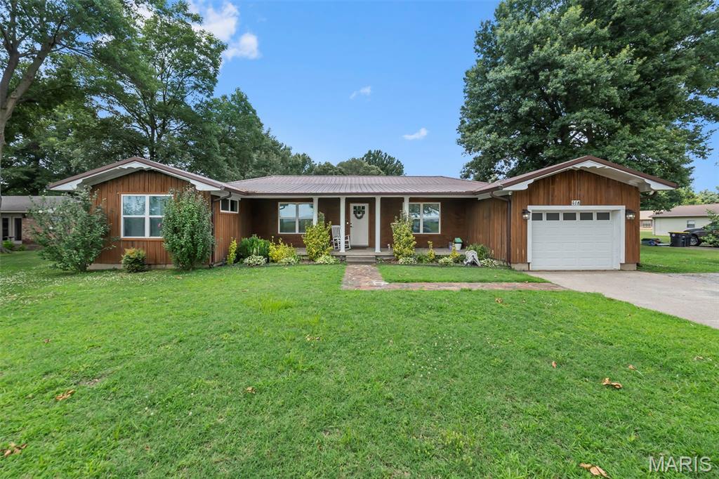 This home feels inviting from the moment you turn into the driveway. A large front porch just made for setting welcomes you to the front door. Inside awaits an open floor plan with spacious living room, dining room, and updated kitchen with lots of white cabinetry and gorgeous granite counter tops. On the back of the house is a beautiful sunroom with a great view of the large backyard and two storage buildings plus there are two addition attached storage rooms, all surrounded by a new white vinyl privacy fence. Back inside, down the hallway, you will find two full updated bathrooms and four bedrooms each with its own roomy closet. Three of which are walk in closets. The entire home has newer matching vinyl planking flooring. Call me to schedule your showing of this great family home today!