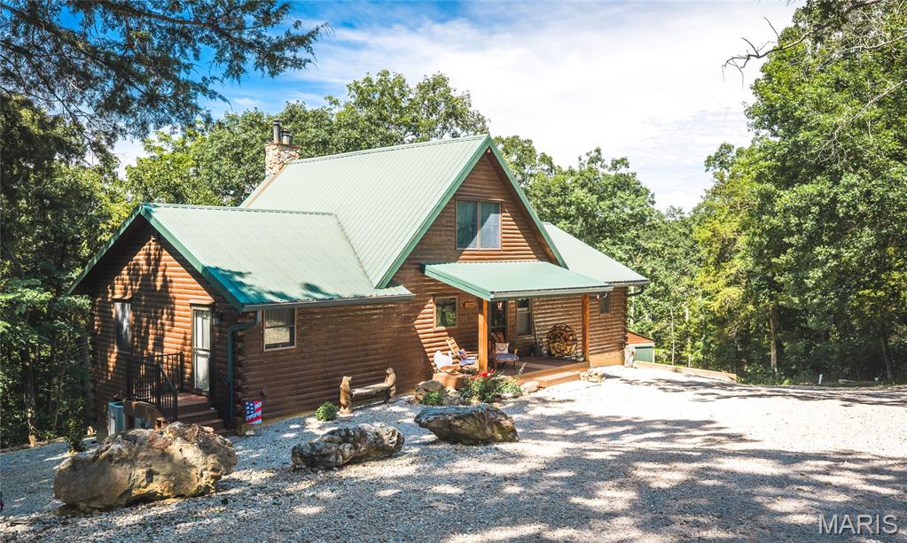 Nestled on 13.2 acres overlooking the Bourbeuse River, this custom cedar log home offers the perfect blend of privacy, comfort, and recreation. Whether you’re looking for a full-time residence or a weekend getaway, the open floor plan welcomes you with stunning views of nature from nearly every room. The main level features a kitchen and dining area with granite countertops, a spacious great room with a beautiful stone fireplace, main floor laundry, and access to the deck where you can enjoy your morning coffee while taking in the river views. The primary suite offers a large walk-in closet and private bathroom, while the loft provides additional sleeping space for guests and overlooks the great room below. The finished walkout lower level creates a cozy retreat with a wood-burning stove, ideal for family gatherings, games, or relaxing after a day outdoors. A third bedroom, full bath, ample storage, and a heated two-car attached garage complete the lower level. Step outside and enjoy approximately 300 feet of direct river frontage with your own private gravel bar, perfect for fishing, floating, trail hikes, and making memories with family and friends. Additional features include a detached 450 sq. ft. garage just steps from the home, woodshed, plus a 576 sq. ft. two-car garage with RV and boat storage located at the entrance to the property. Recent updates include newer flooring throughout, updated bathrooms, a newer furnace, and a water filtration system. As an added bonus, all appliances, washer and dryer, TVs, a stunning 12-foot Christmas tree perfectly suited for the great room, and a two-person deer blind will remain with the property, making this one-of-a-kind riverfront retreat move-in ready and ready to enjoy. Schedule your showing today!