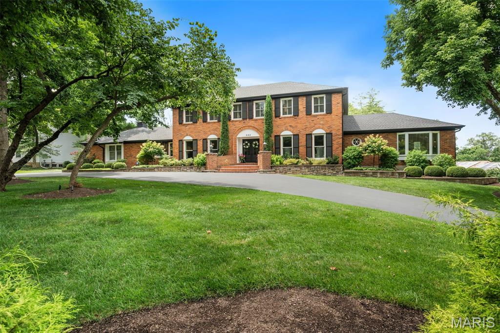 Some homes impress you; this one welcomes you. Warm, gracious and beautifully cared for, this exceptional Ladue Downs residence offers the unmistakable feeling of home from the moment you arrive. Ideally situated off Ladue Road, it combines timeless architecture and thoughtful updates with more than 5,600 square feet of finished living space, including seven bedrooms and six bathrooms. Positioned on an expansive, professionally landscaped corner lot, the home makes a memorable first impression with its circular drive and stately French-door entry. Inside, gleaming red oak hardwood floors extend throughout the main level, where a gracious foyer and elegant staircase are flanked by formal living and dining rooms designed for memorable entertaining. The spacious family room features a gas fireplace and dry bar, while a full-view glass door creates a seamless connection to the outdoor living spaces, newer free-form pool and lush grounds. The newly renovated gourmet kitchen is equally suited for everyday living and elevated entertaining, featuring beautifully crafted Plato cabinetry, high-end Thermador appliances, a wine refrigerator and a striking quartz island with seating. Two primary suites—one on each level—offer remarkable flexibility. The main-floor suite is a serene retreat with two generous closets, a spa-inspired bath and private access to the expansive composite deck overlooking the pool and grounds. Upstairs, the second primary suite provides extraordinary privacy and space with two walk-in closets and an updated spa-like bath. Four additional bedrooms and two full baths complete the upper level. The finished walkout lower level further expands the home’s living and entertaining space with a fireside sitting area; wet bar with two beverage centers, cabinetry and sink; fitness room; recreation area ideal for billiards; additional bedroom; and full bath. An oversized three car rear entry garage complete this special home. Offering an exceptional balance of privacy, convenience and refined comfort, this distinctive property presents an extraordinary lifestyle in one of the area’s most desirable neighborhoods minutes from shopping, dining, major highways and St. Louis premier medical facilities.