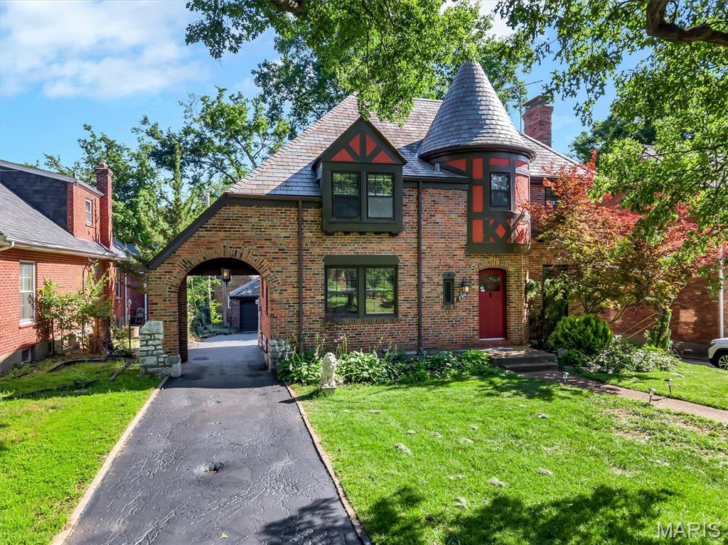 Welcome Home to 7312 Ravinia Drive! Nestled in the heart of Pasadena Hills, you’ll fall in love with more than just this charming Tudor style home; you’ll also fall in love with the neighborhood. Known for its winding tree lined streets, picturesque pond, iconic stone statues, and beautifully preserved homes, Pasadena Hills provides a storybook setting unlike any other. Admire the home’s timeless architecture from the moment you arrive, highlighted by its distinctive turret and classic carriage porch leading to the backyard. Inside, original hardwood floors, stained glass windows, and historic details showcase the craftsmanship and charm that make this home so beloved. The living room features a decorative fireplace and cozy reading nook, creating the perfect space to relax and unwind. The dining room seamlessly connects to the updated kitchen with adjacent breakfast room offering modern convenience while maintaining the home’s historic charm. Upstairs you’ll find three comfortable bedrooms and full bath. The lower level provides additional living space with a den featuring the home’s second decorative fireplace and convenient half bath. Outside, the manageable backyard offers a shaded patio, small grassy area, and two car garage. More than just a home, Pasadena Hills offers a lifestyle centered around architectural beauty, neighborhood appeal, and a feeling of community. Its central location near major highways provides convenient access to Clayton, Downtown St. Louis, and all your favorite shopping, dining, and entertainment destinations. Don't wait around and miss your chance to own a piece of St. Louis history!