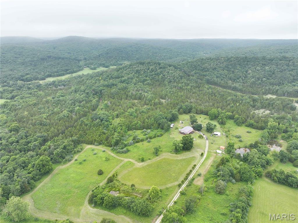Nestled in the heart of the Ozarks near Elephant Rocks State Park and Johnson's Shut-Ins State Park, this exceptional property offers approximately 34.53 acres m/l of scenic beauty and privacy. The main residence features approximately 2,400 sq. ft. with 3 bedrooms and 2 bathrooms, making it ideal as a full-time home, weekend retreat, or vacation rental. A second manufactured home on the property offers approximately 1,080 sq. ft. with 3 bedrooms and 2 bathrooms, providing excellent potential for guest accommodations, rental income, or multi-generational living. Enjoy breathtaking views, two spring-fed ponds, abundant wildlife including whitetail deer and wild boar, and excellent hunting opportunities. The property also features several fruit trees, ample space for livestock, and room for all your outdoor hobbies. Located off Hwy N in Middlebrook, this peaceful and secluded setting offers the perfect combination of recreation, relaxation, and country living.